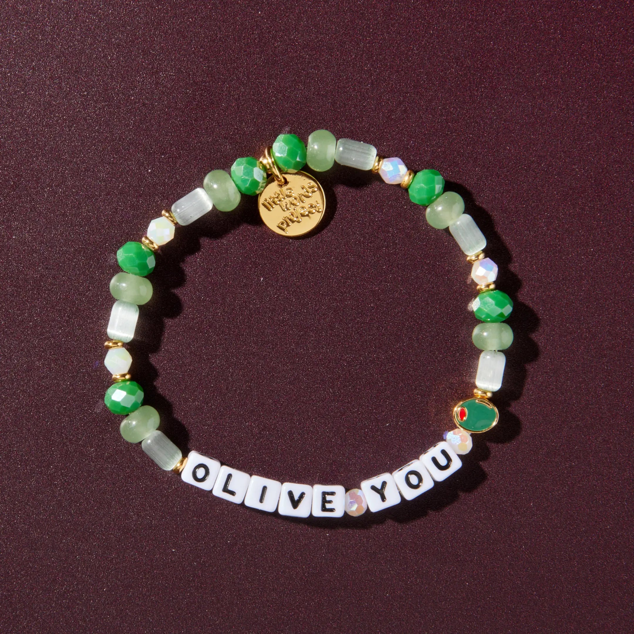 Beaded bracelet with 'OLIVE YOU' on a dark background