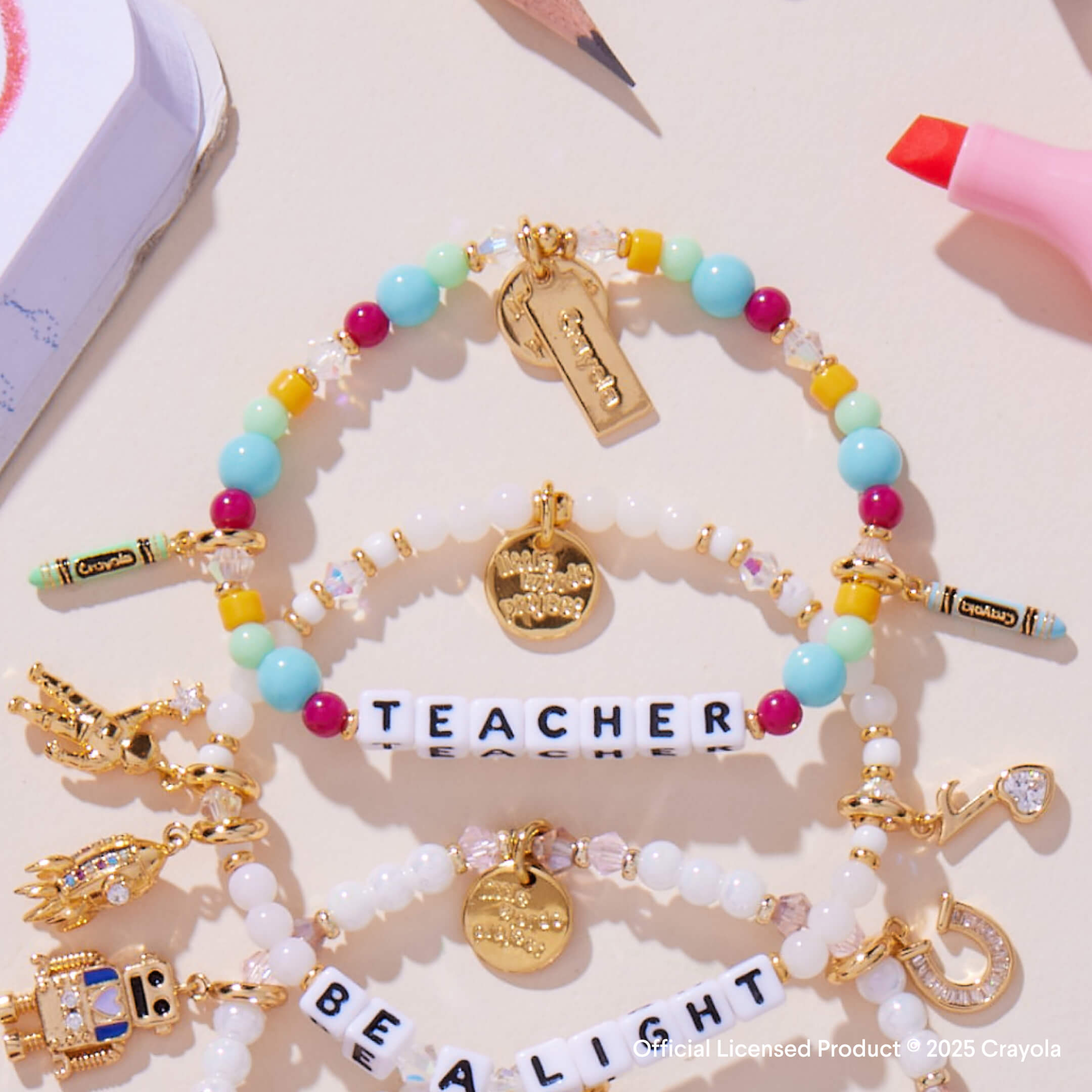 Colorful beaded bracelets with charms on a light background