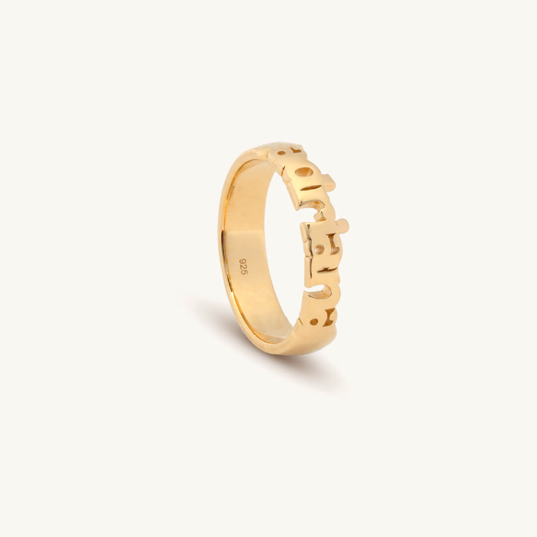 Gold ring with 'Adriana' engraved on a white background