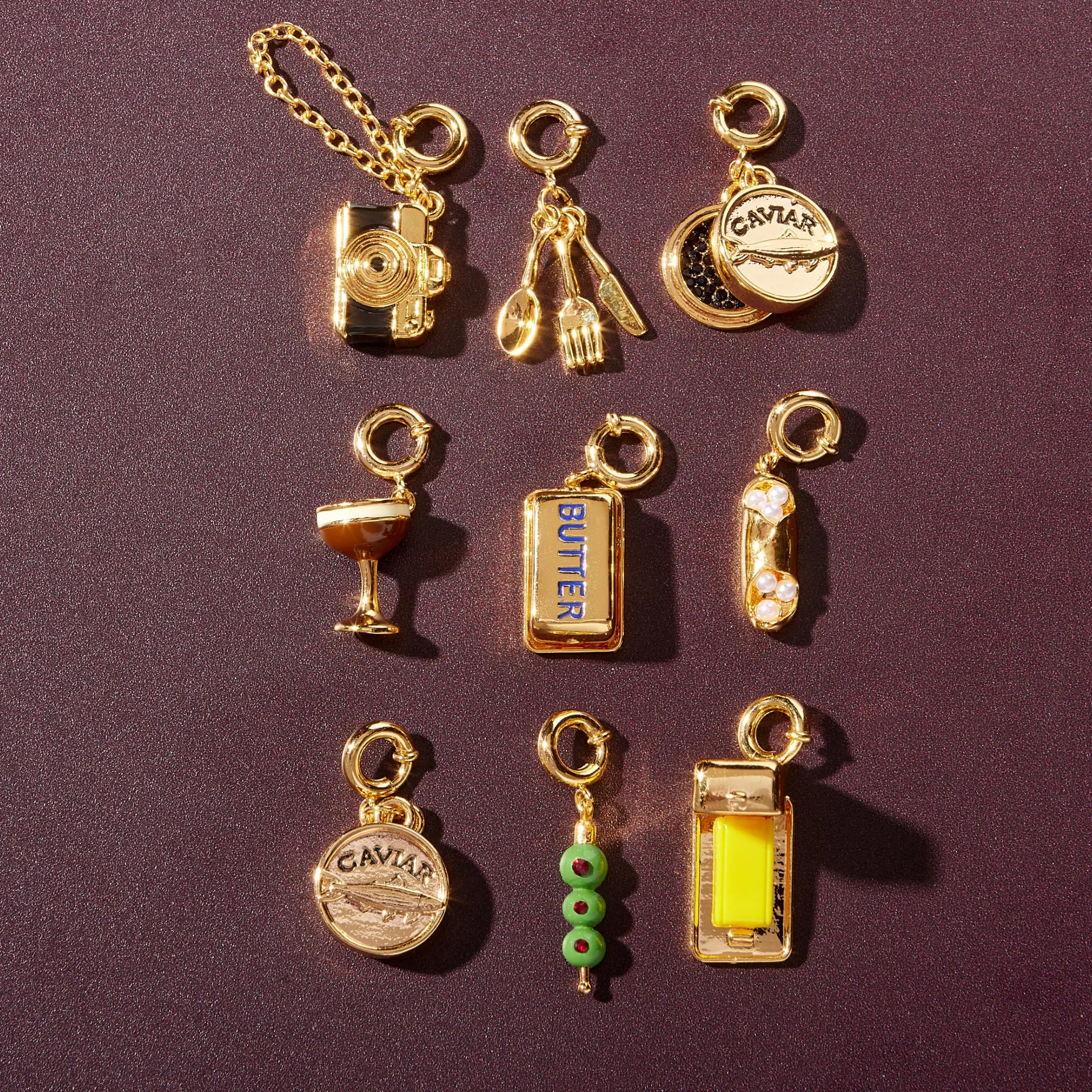 Collection of gold charms on a purple background
