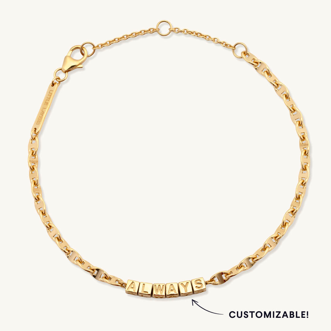 Gold chain bracelet with 'ALWAYS' text on a white background