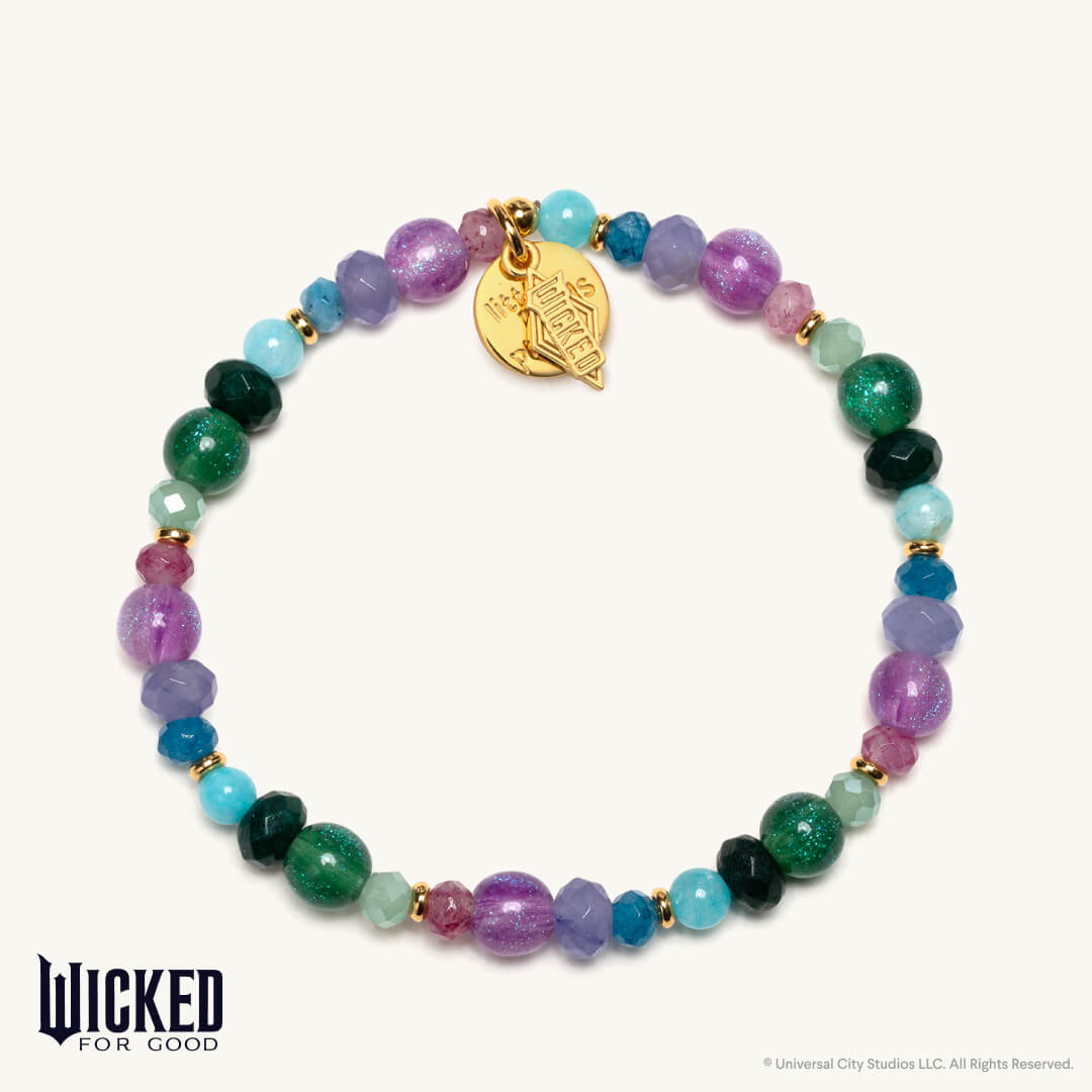 Multicolored beaded bracelet with a gold charm on a white background, featuring the 'Wicked for Good' brand.