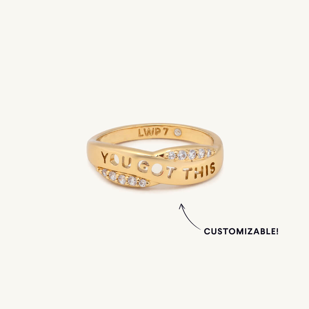 Gold ring with 'YOU GOT THIS' text on a white background