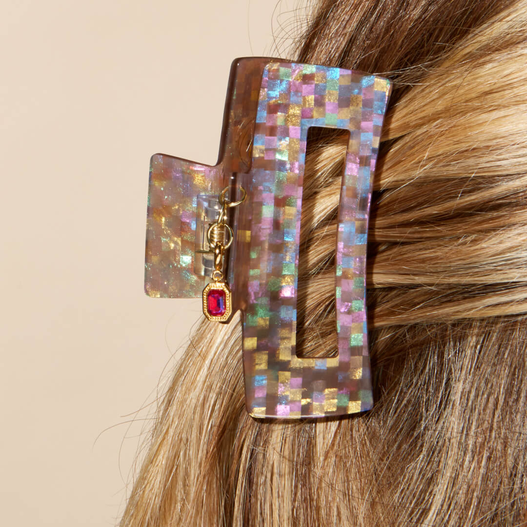 Hair clip in hair with a charm on it