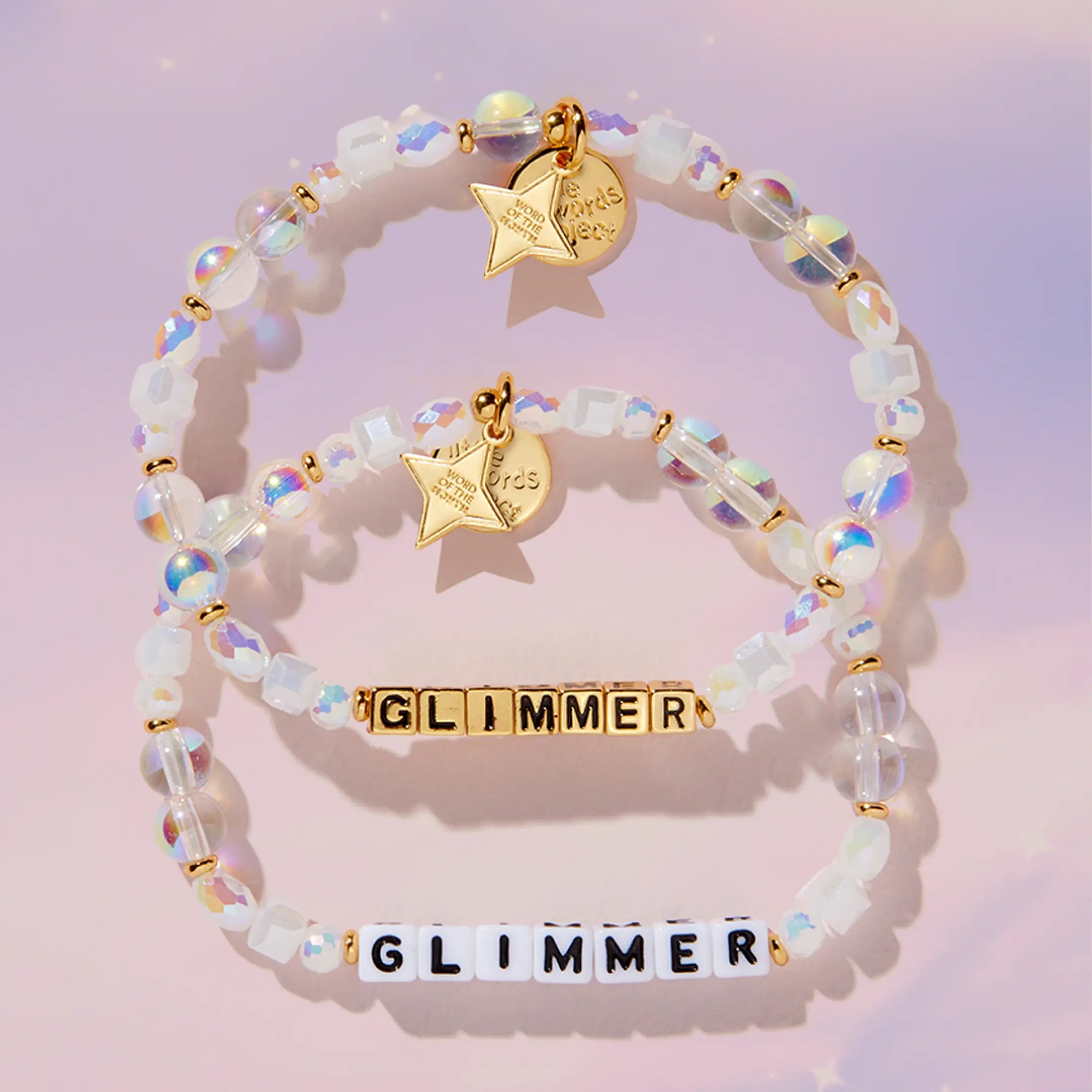 Two beaded bracelets with gold charms and 'Glimmer' text on a pink background