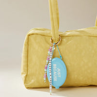 You Deserve A Treat Bag Charm lifestyle flat lay