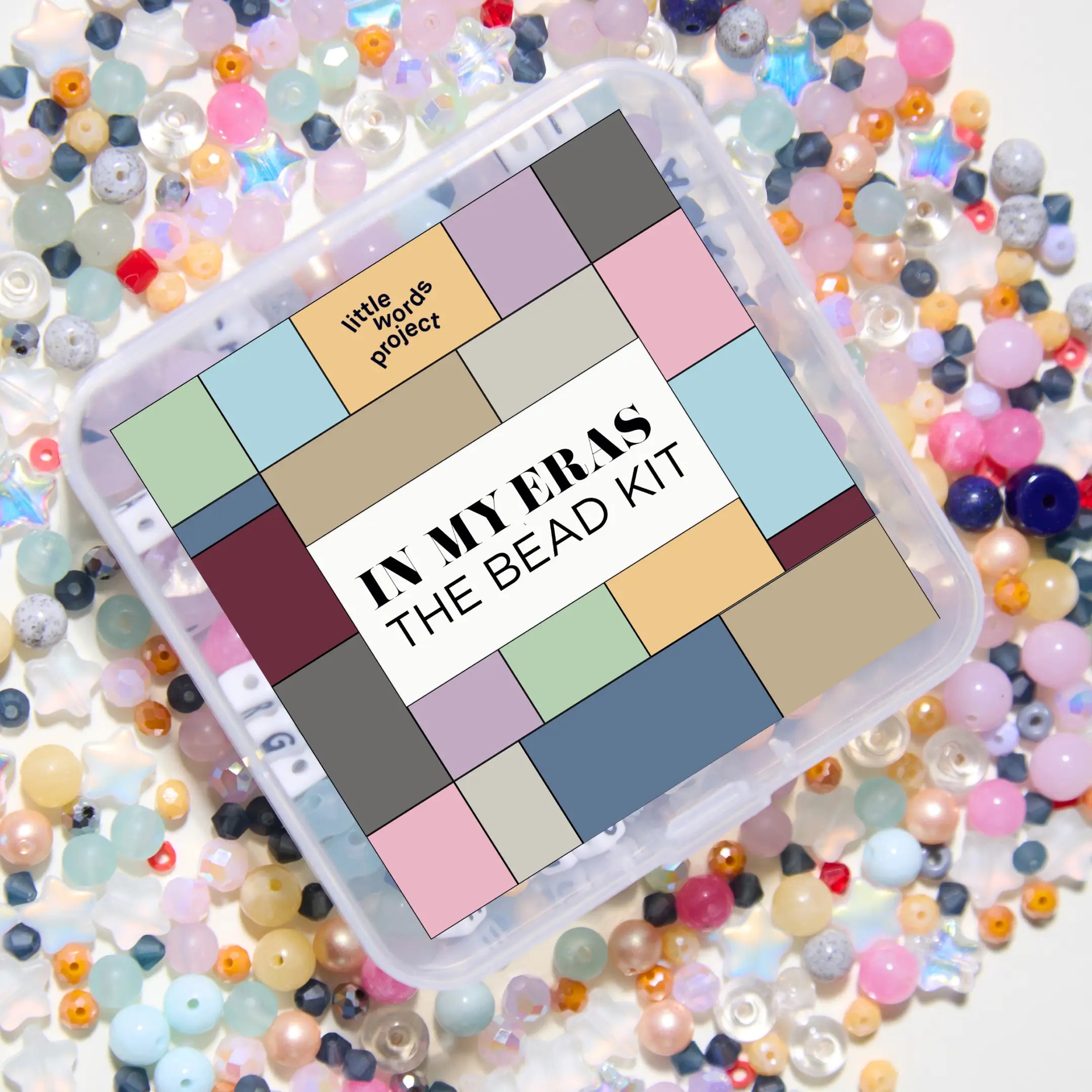 Bead kit with colorful beads on a white background