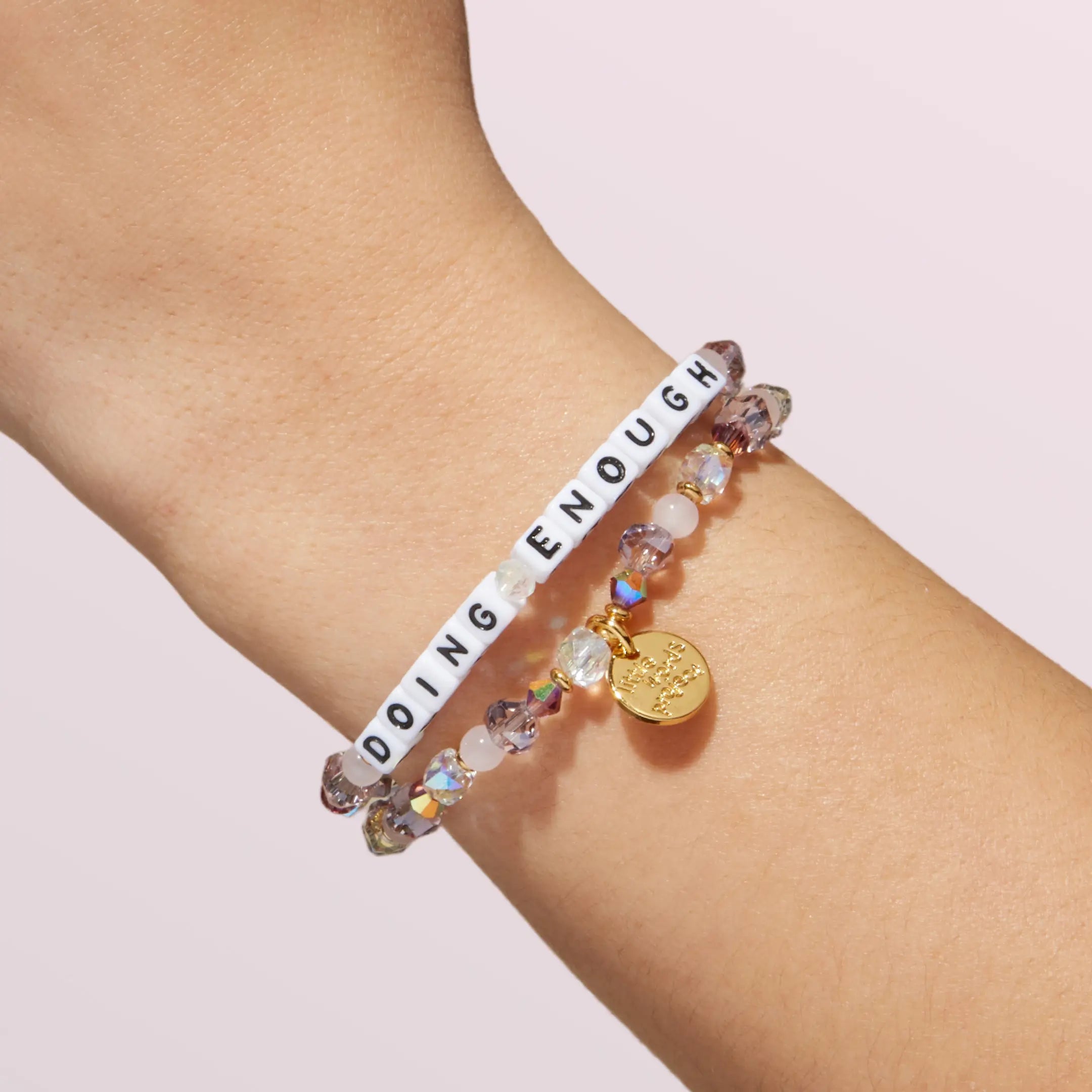 Bracelet with motivational message on wrist against a light background