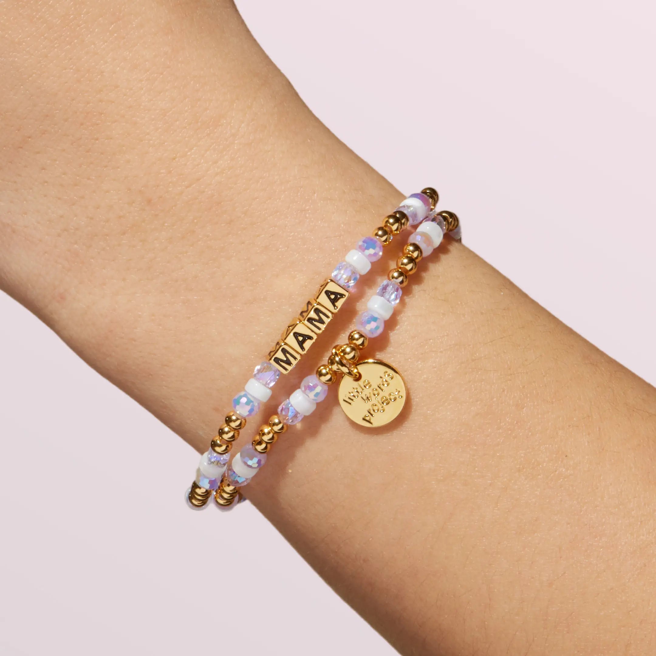 Bracelet with 'MAMA' on a wrist against a light background