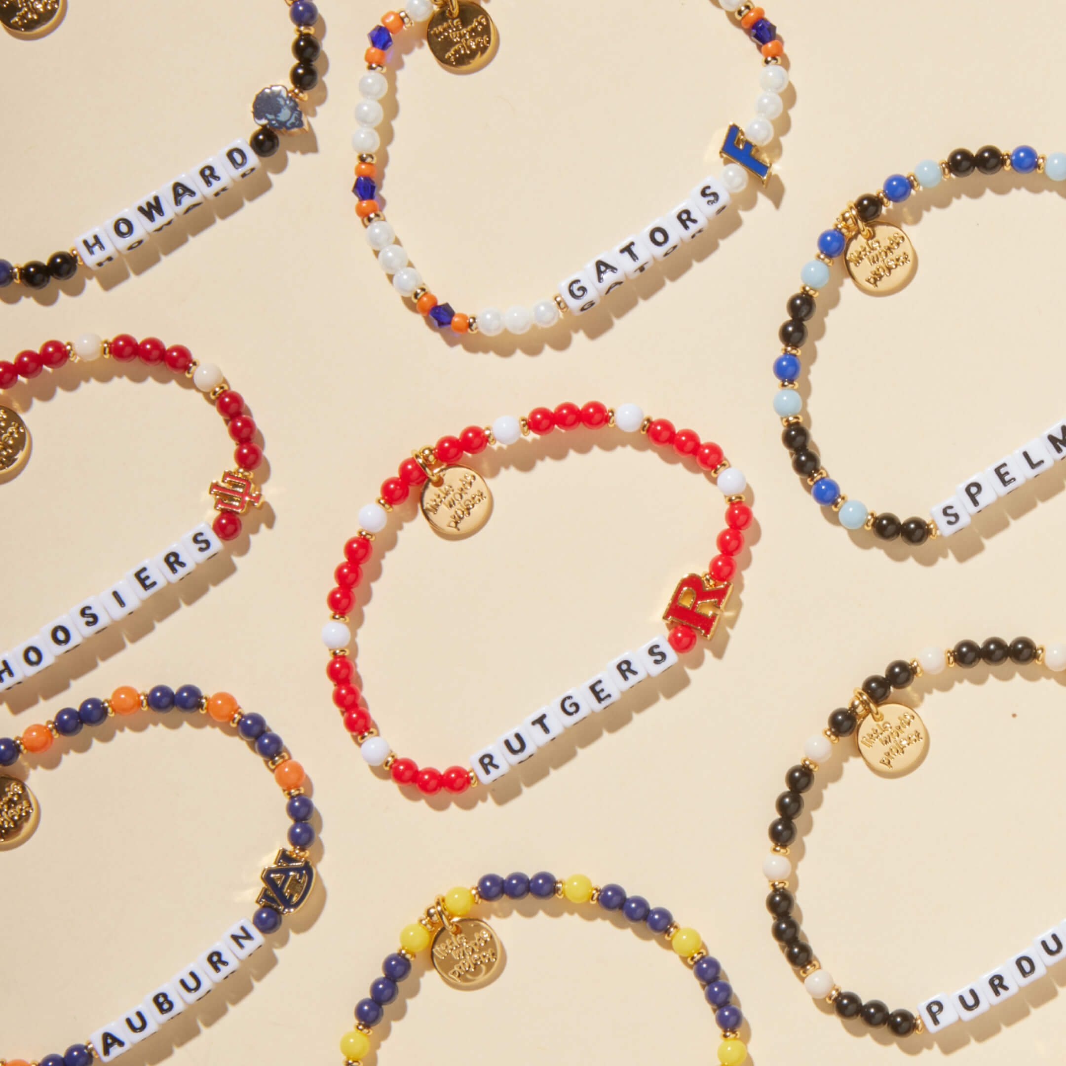 Colorful beaded bracelets with text on a beige background