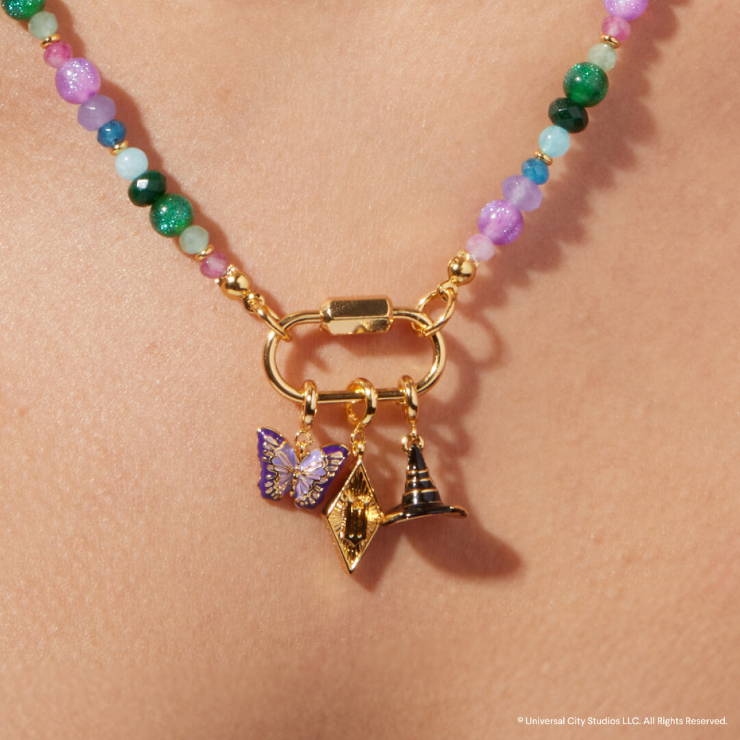 Necklace with colorful beads and gold charms on a person's neck