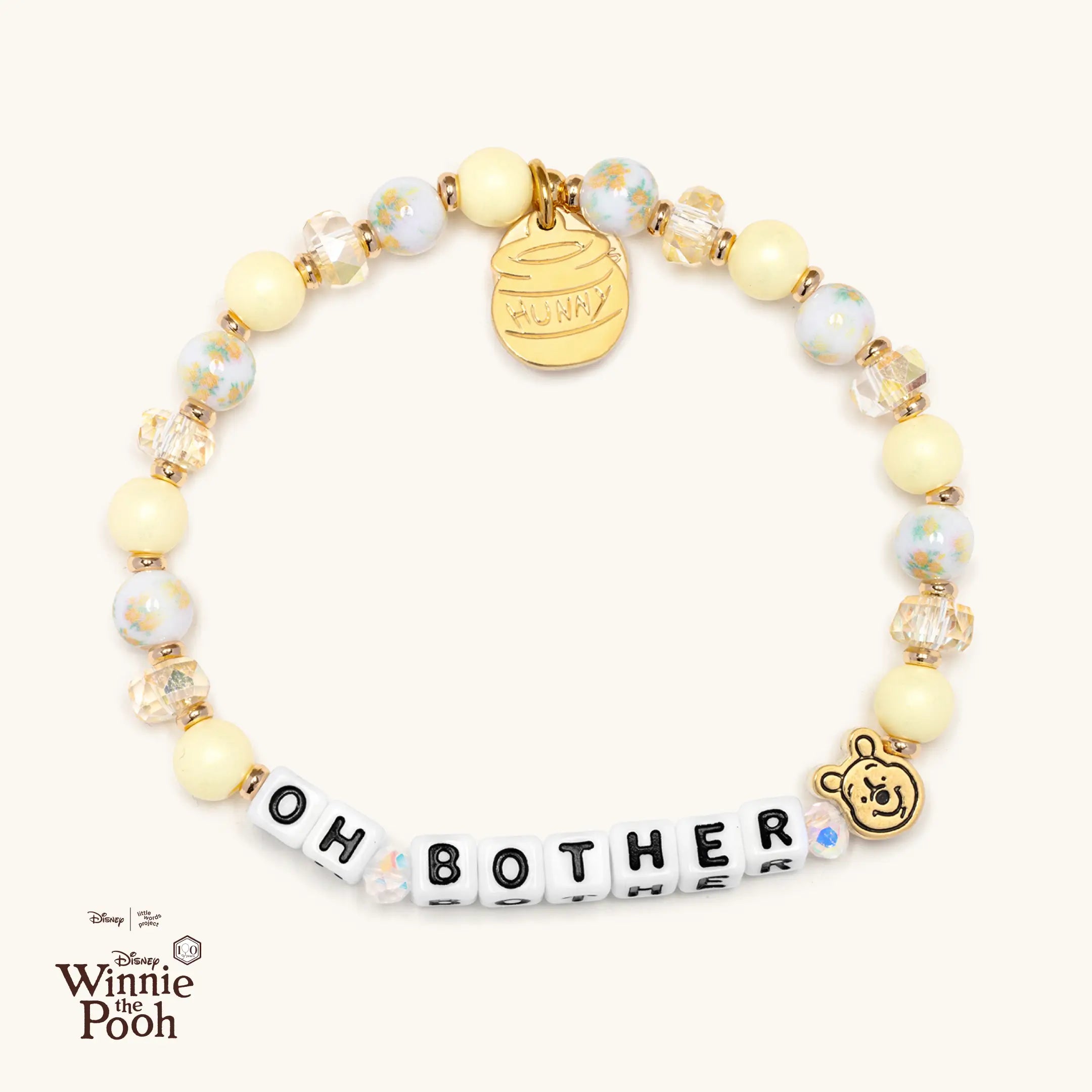 Bracelet with 'OH BOTHER' and Winnie the Pooh casted bead on a white background