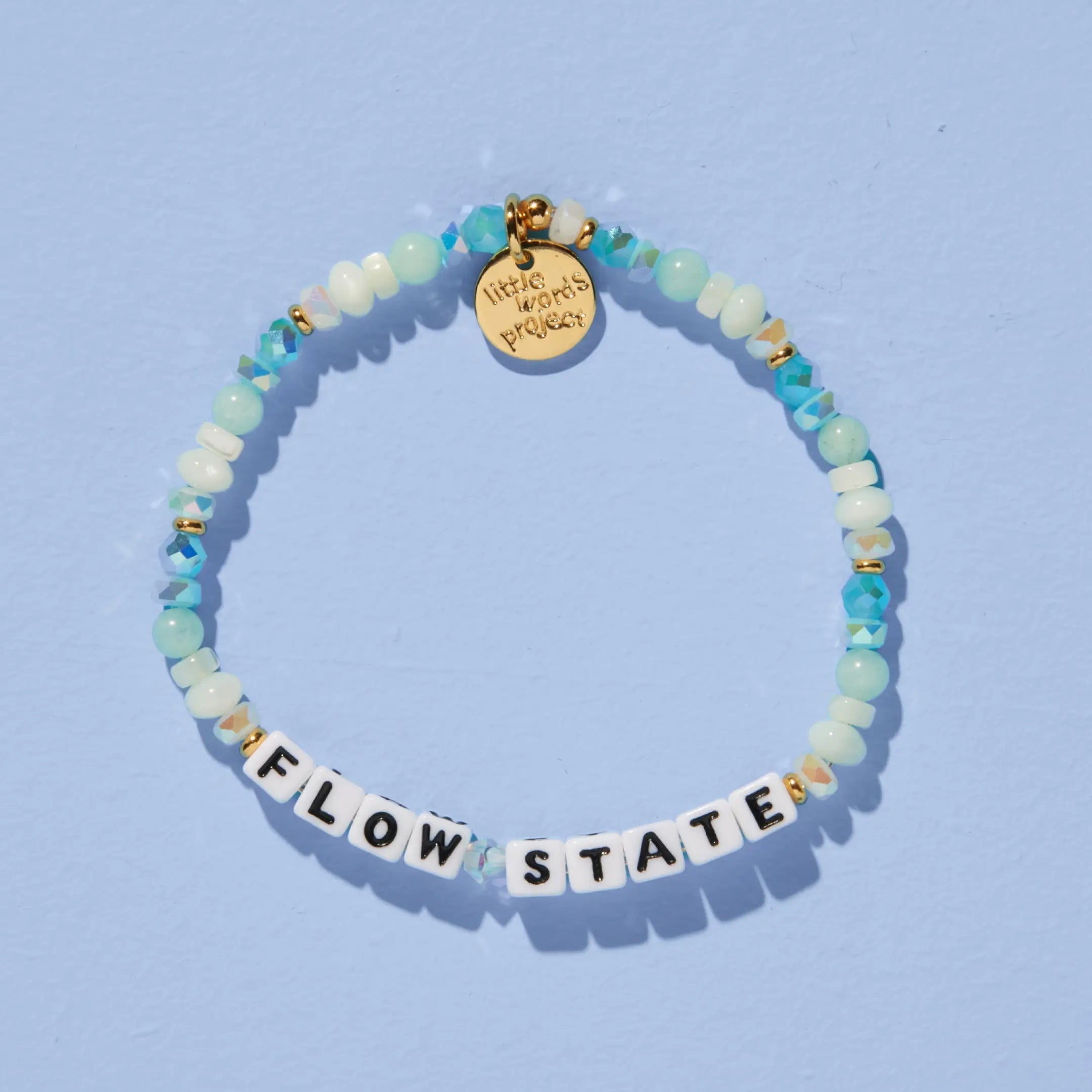 Flow State — on-model shot of beaded word bracelet stacked on wrist