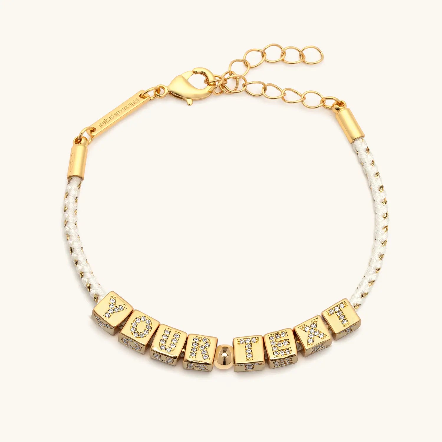 Gold bracelet with letter beads spelling 'YOUR TEXT' on a white background