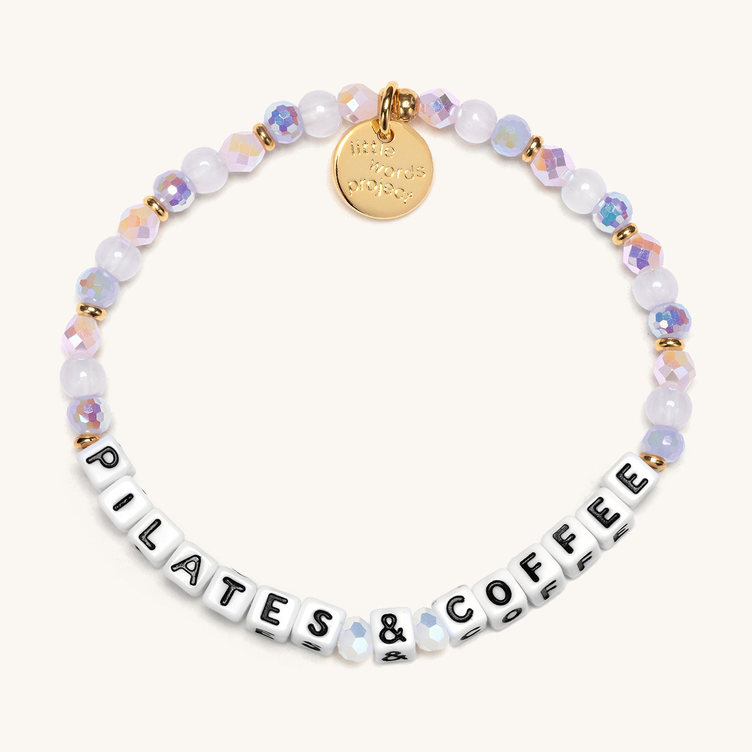 Bracelet with 'Pilates & Coffee' beads and a gold tag on a white background