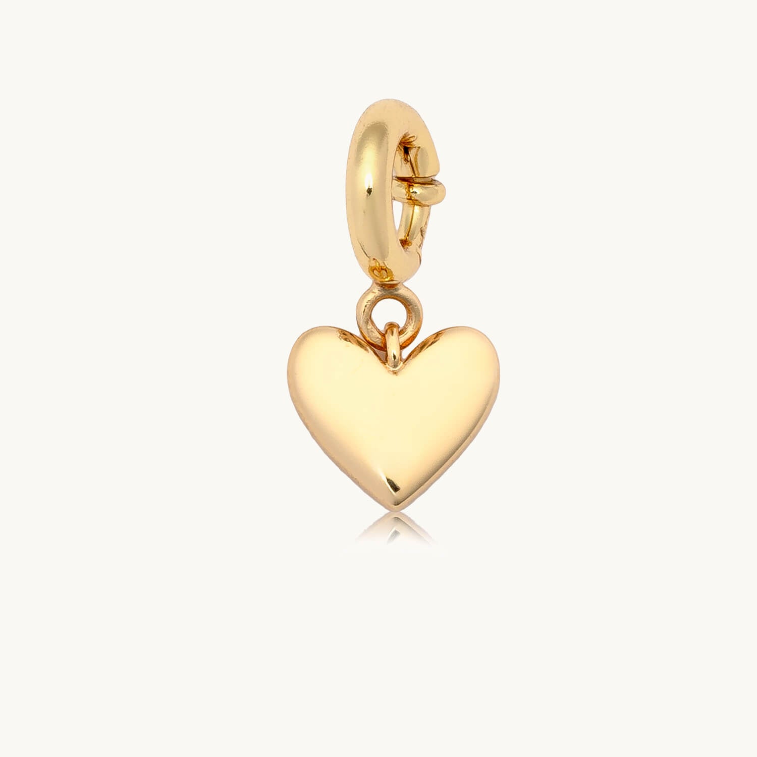 Gold heart-shaped charm on a white background