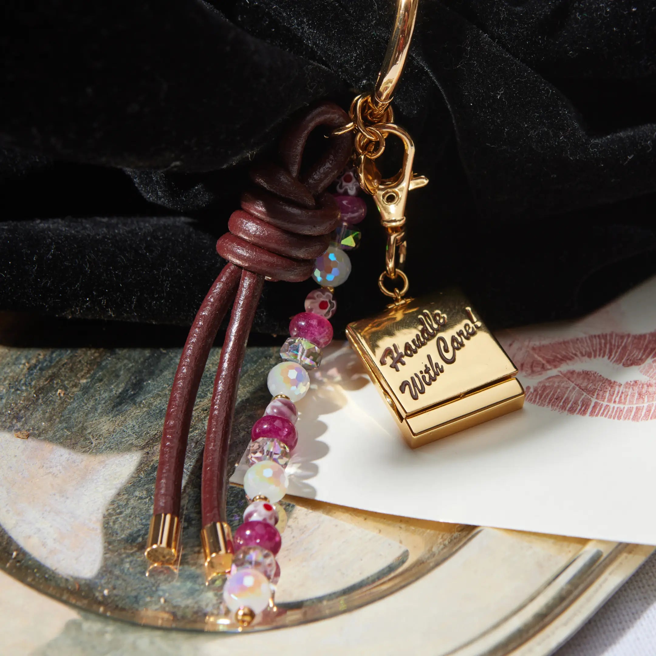 Keychain with beads and gold clasp on a textured surface
