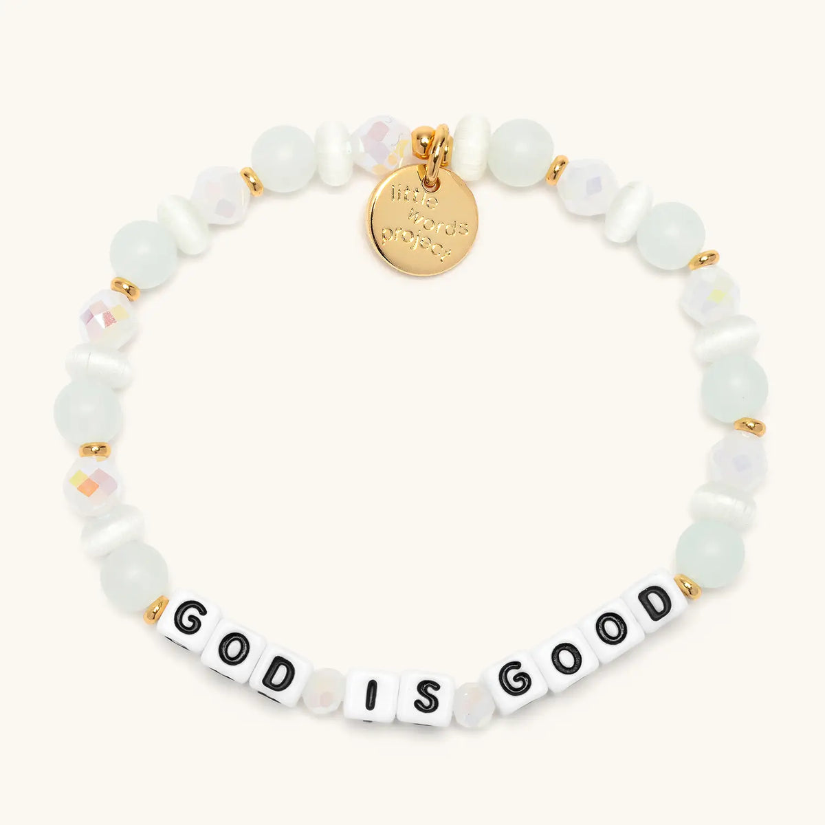 God is Good bracelet from the Faith Bracelet Set, Luxe Knit bead pattern with white cat eye and frosted white beads, flat-lay on cream background