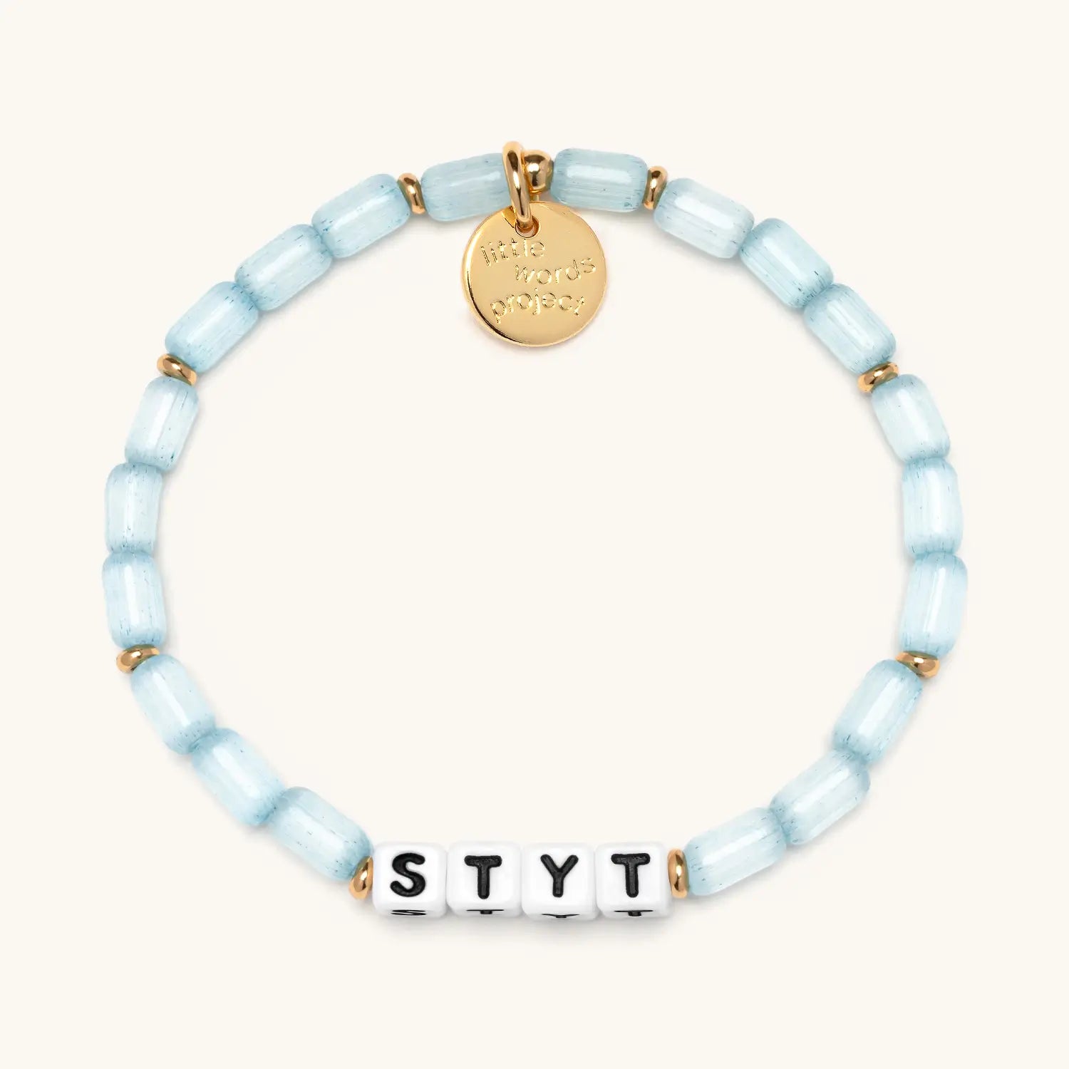 Bracelet with light blue beads and a gold tag on a white background