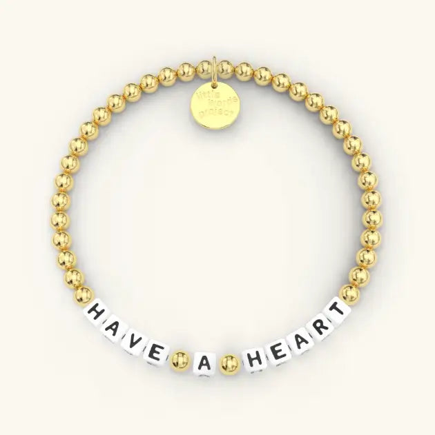 Gold beaded bracelet reading 'HAVE A HEART' on a white background