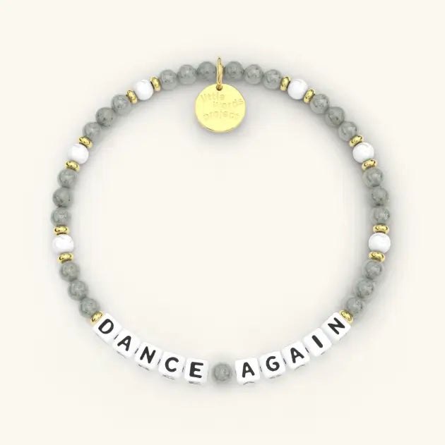 Bracelet with gray beads and gold accents on a white background