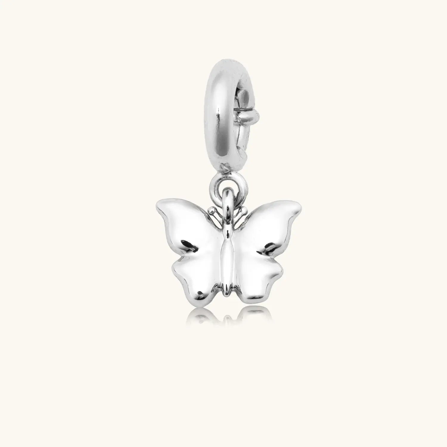 Silver butterfly charm pendant with white enamel wings and a spring-ring clasp, shown on a white background.