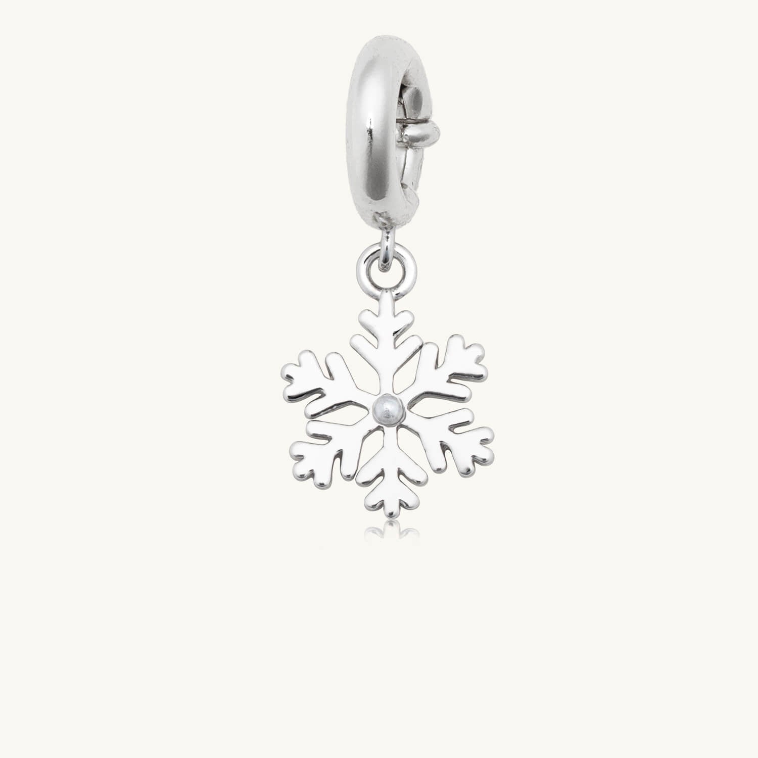 Silver snowflake charm on a white background