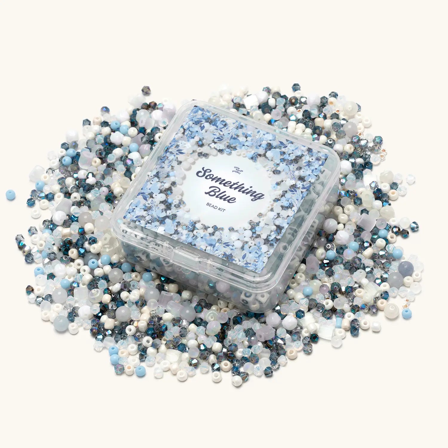 Clear square Something Blue bead kit box surrounded by spilled loose beads in light blue, white, cream, and navy crystal tones