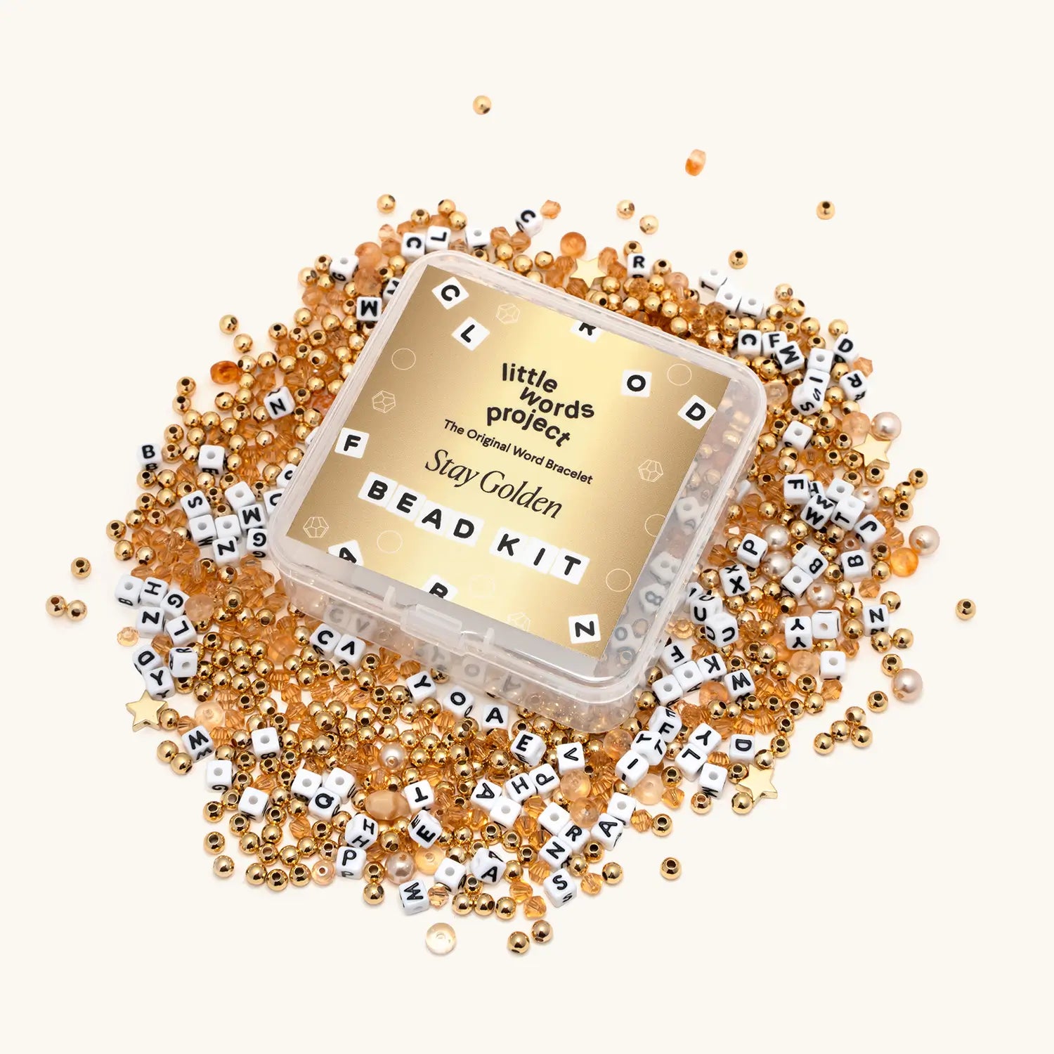 Bead kit with gold beads and letter beads on a white background