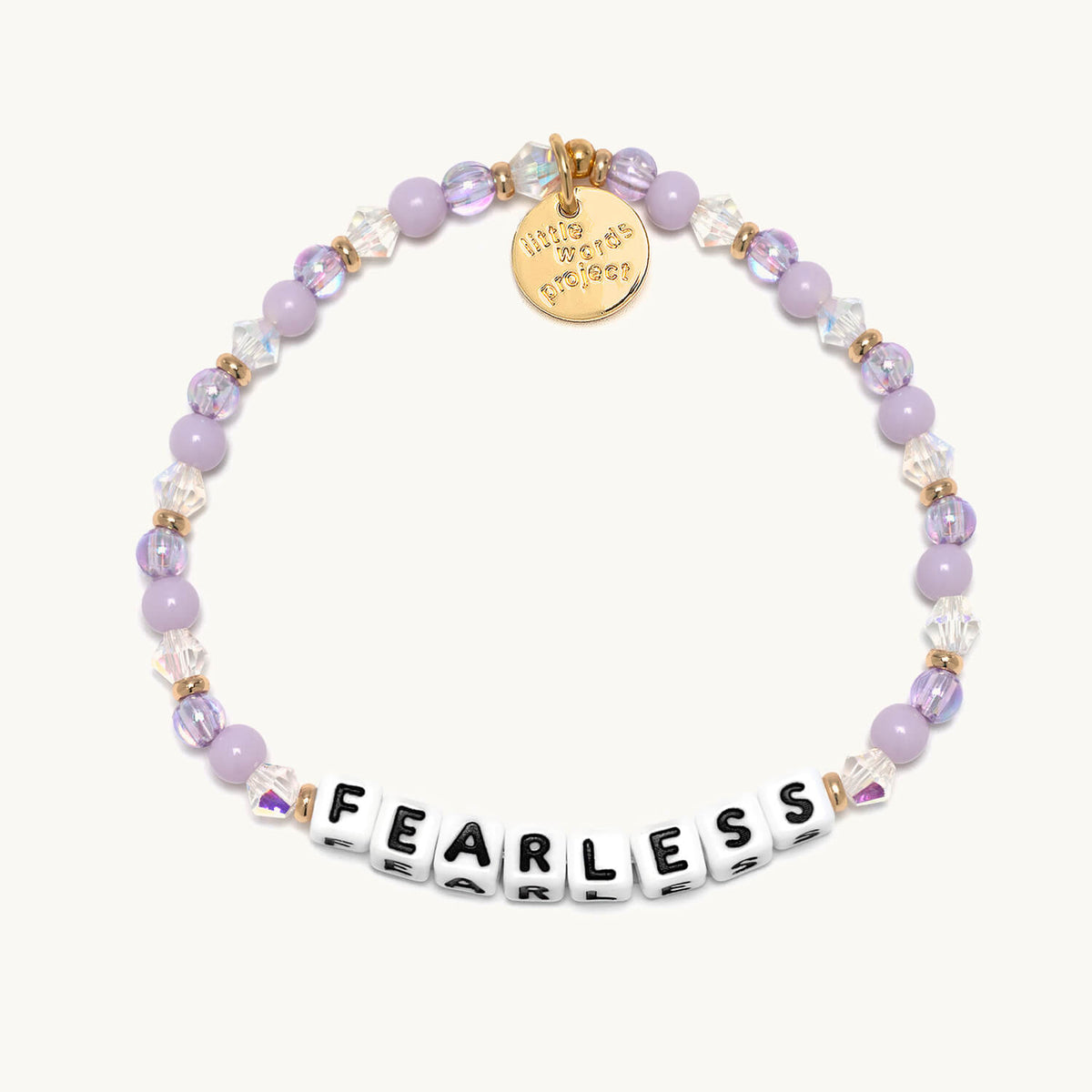 Fearless bracelet with white letter beads from the Soft & Strong Bracelet Set, flat-lay on cream background