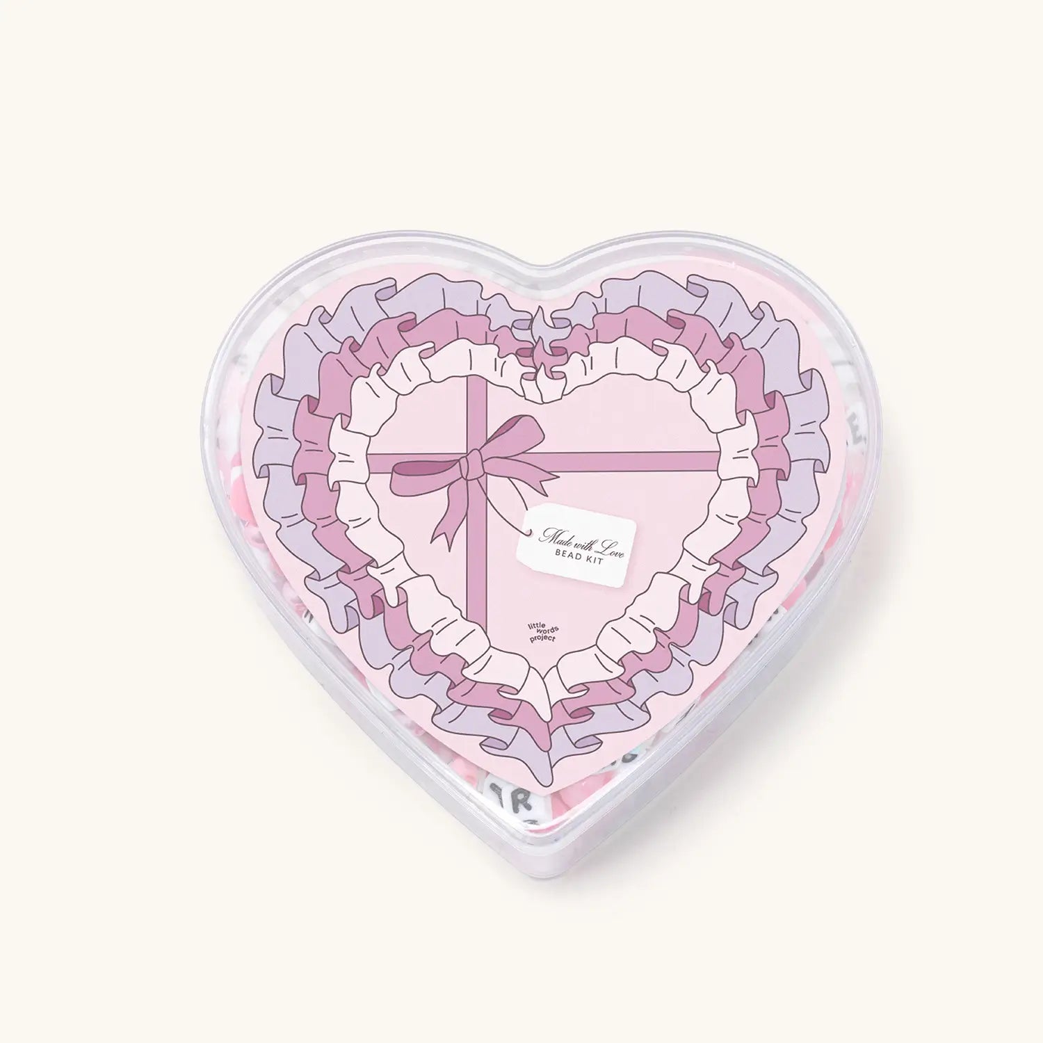 Heart-shaped box with pink ribbons and a bow on a white background