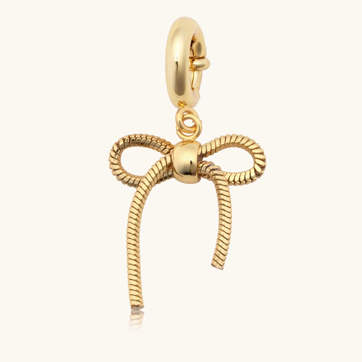 Gold bow-shaped charm on a white background