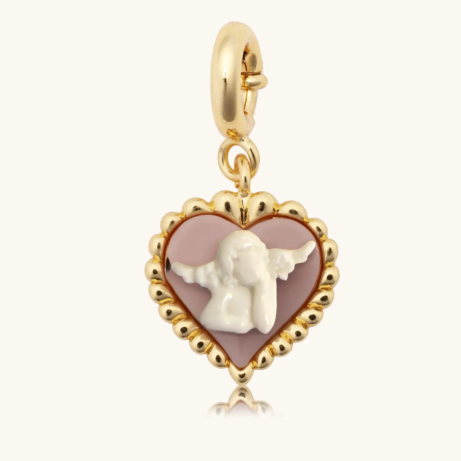 Gold charm with heart design and angel figure on a white background