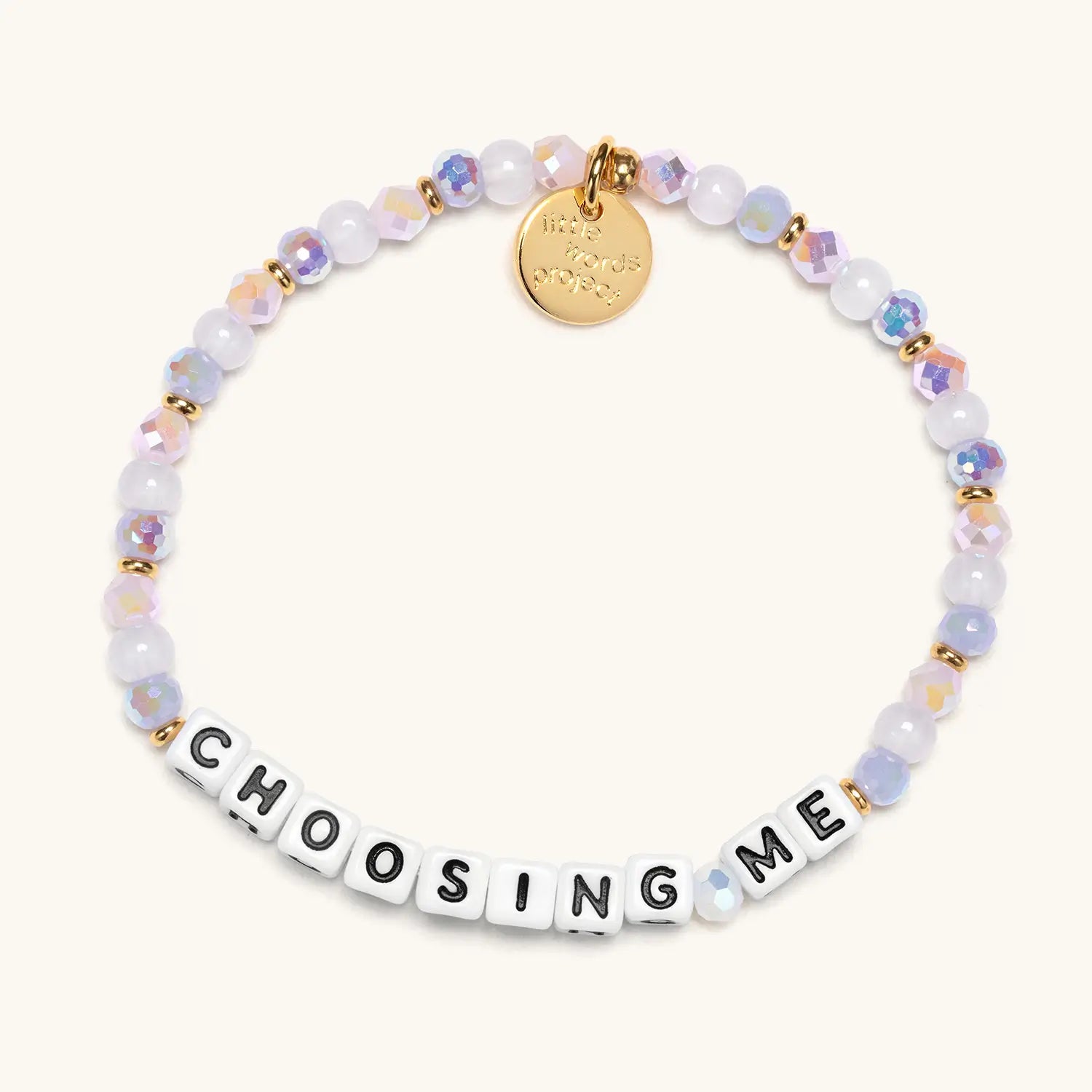 Bracelet with beads and a gold tag on a white background