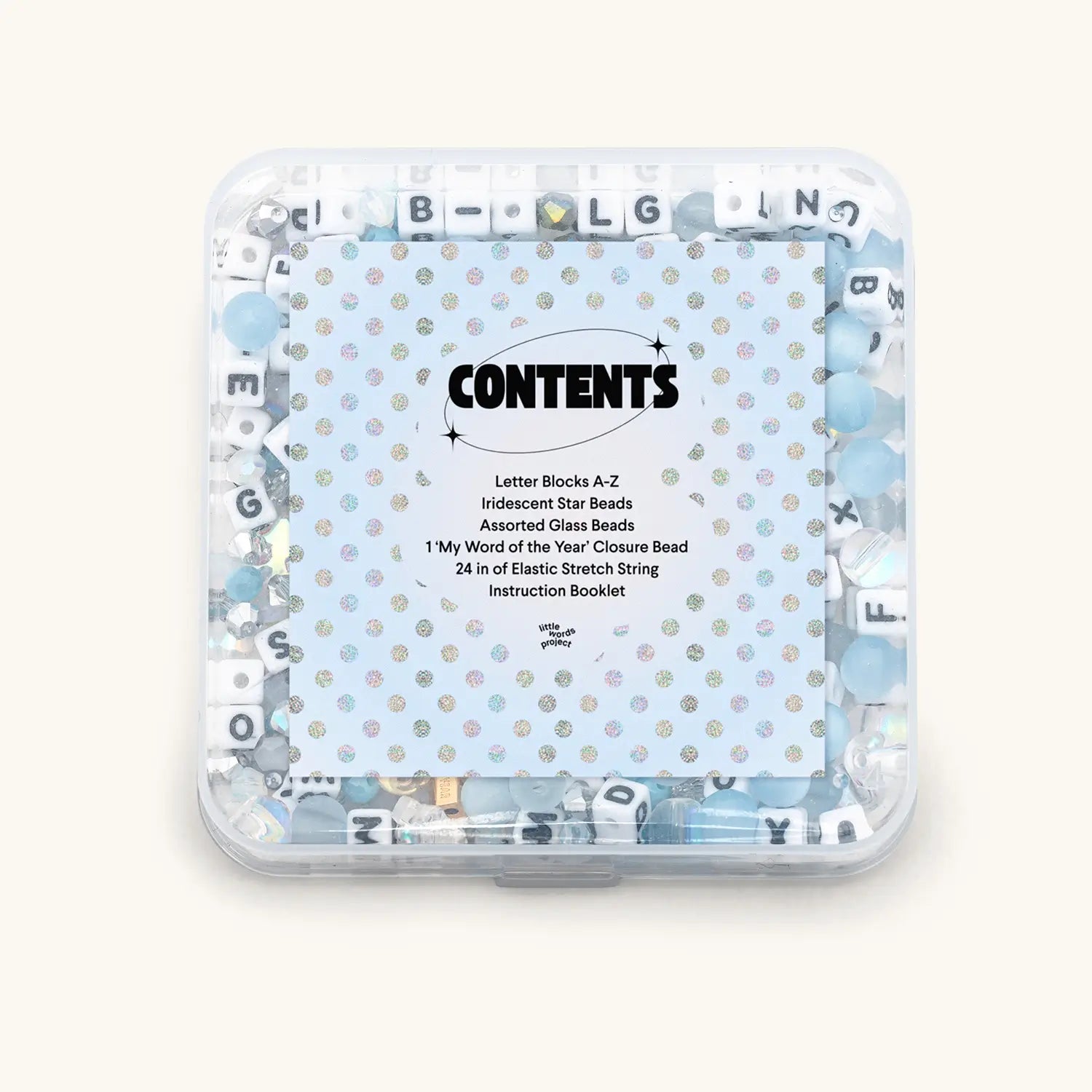 Clear container with letter blocks and beads on a white background