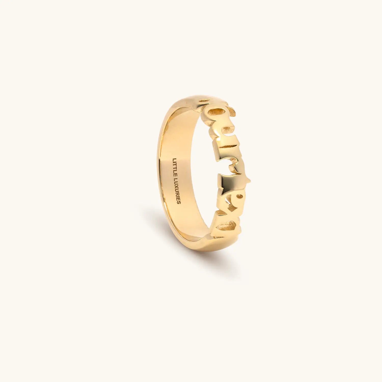 A gold ring with yourtext on it, shown on a clean off-white background.