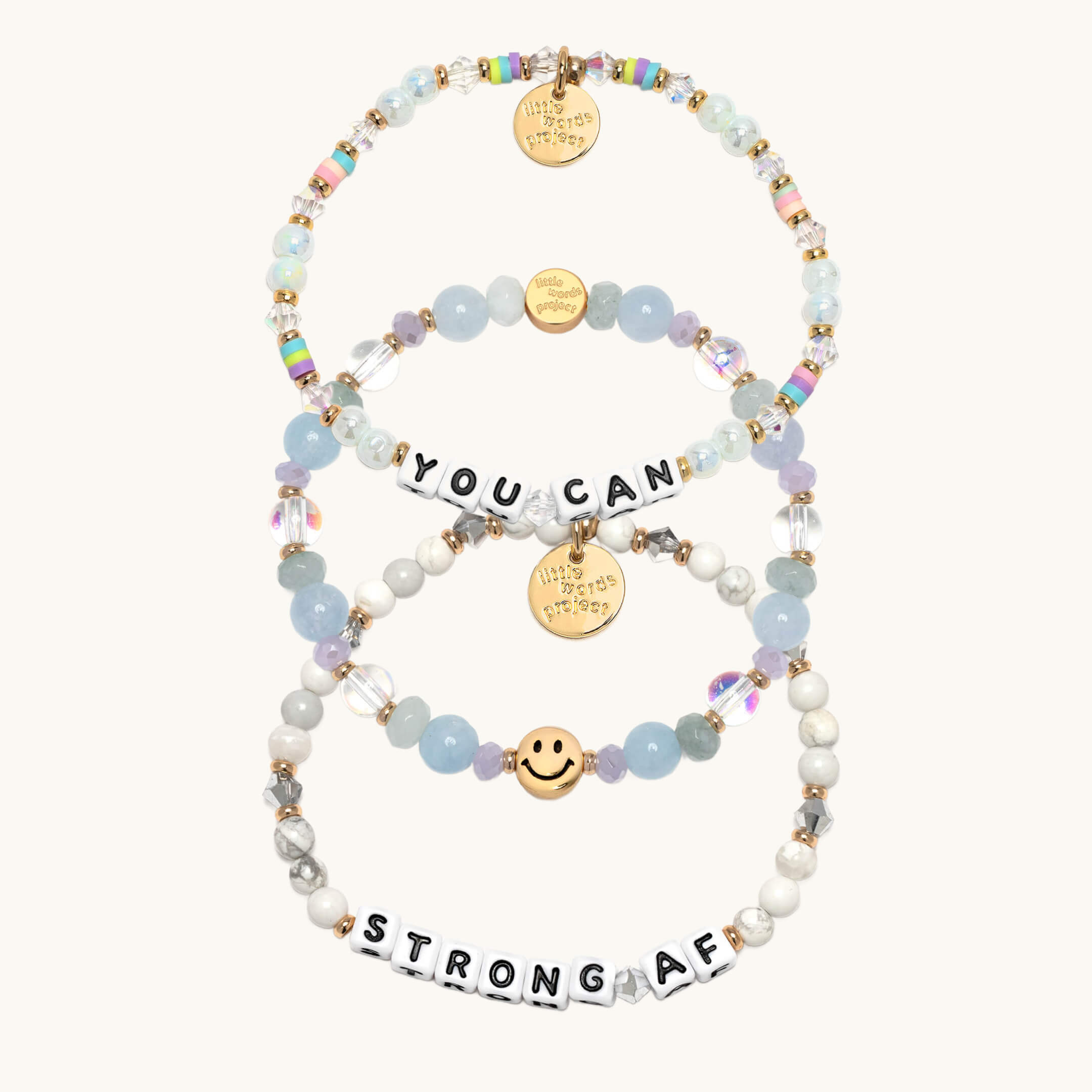 Set of beaded bracelets with motivational phrases on a white background