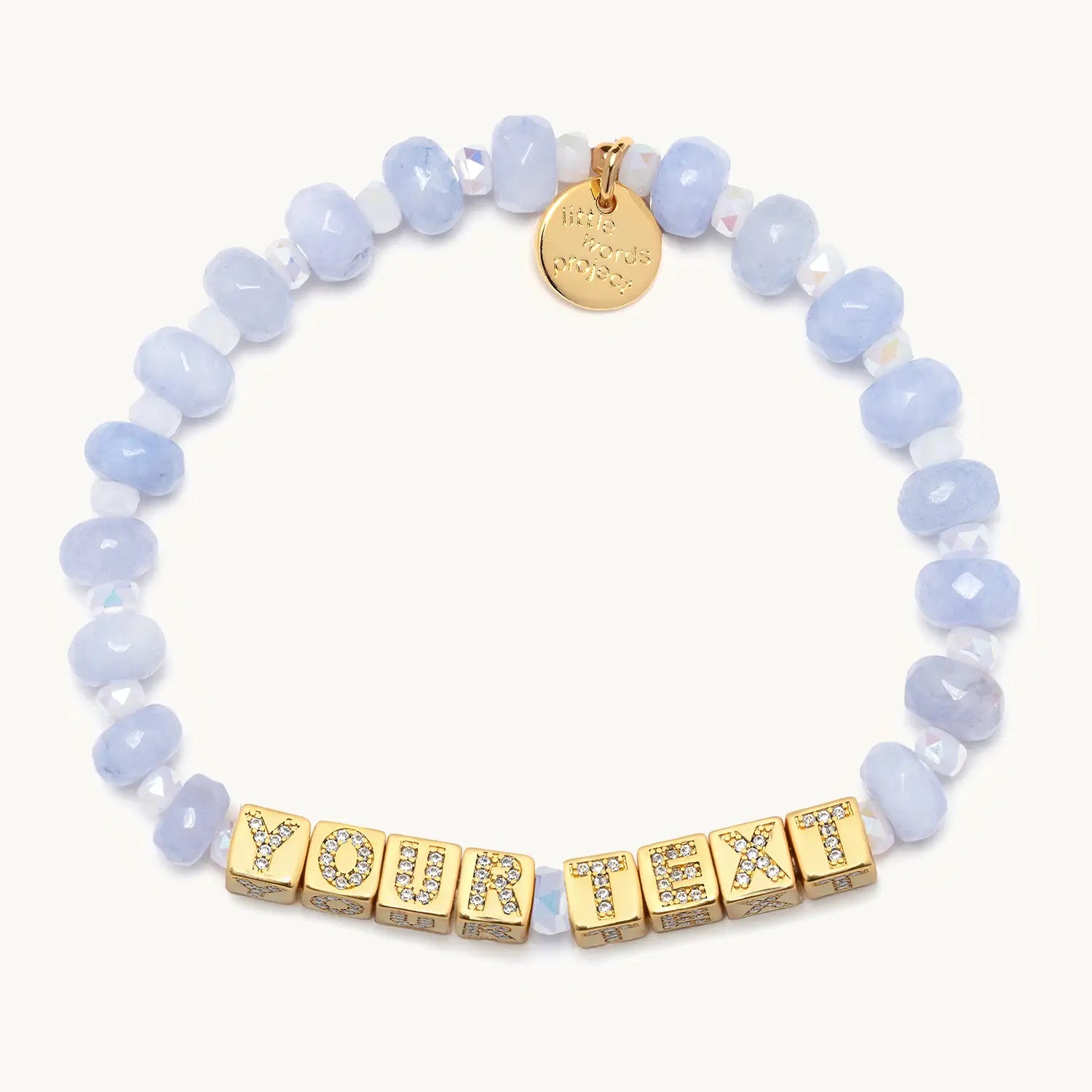 Bracelet with light blue beads and gold letter beads spelling 'YOUR TEXT' on a white background