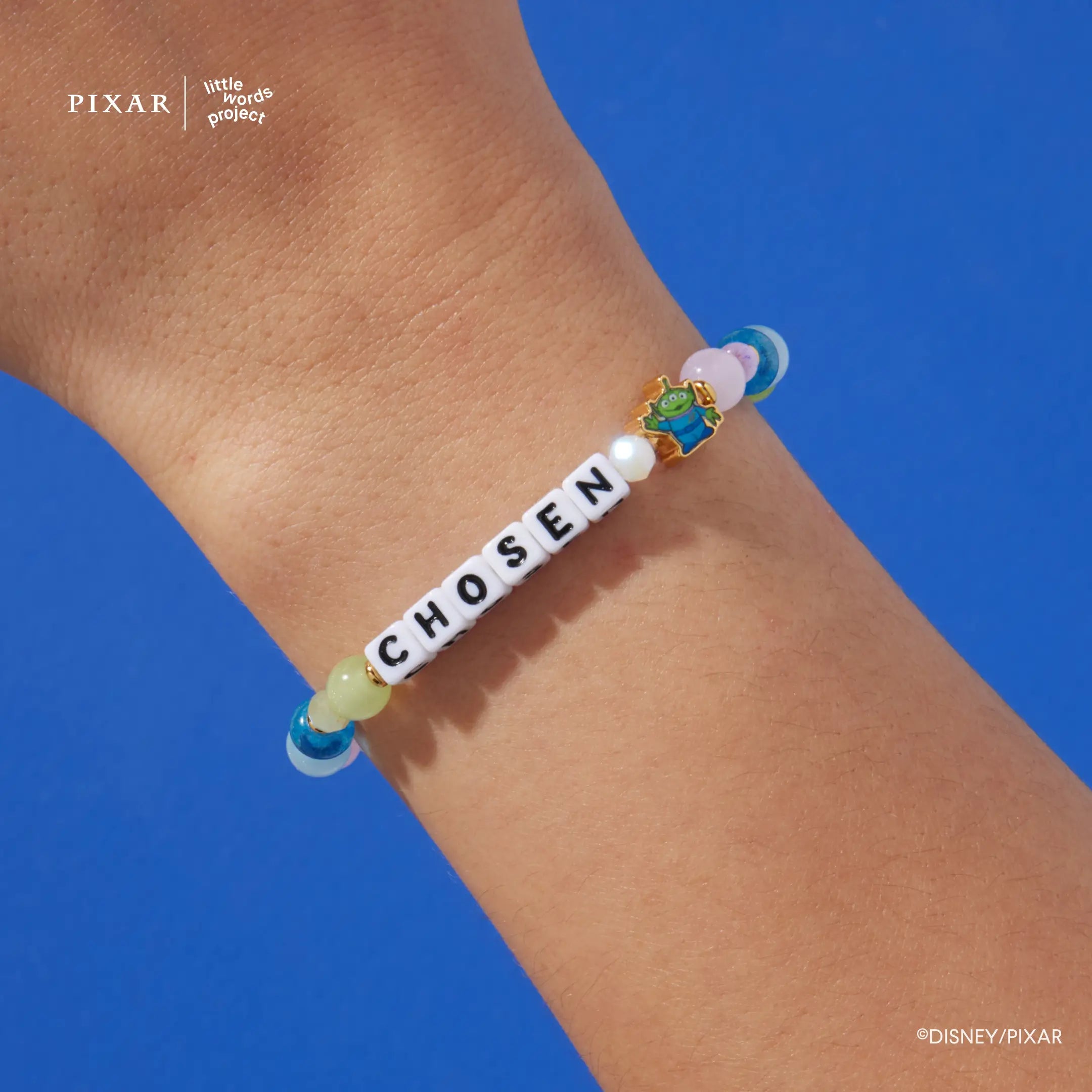 Chosen Toy Story bracelet worn on a model's wrist against a blue background