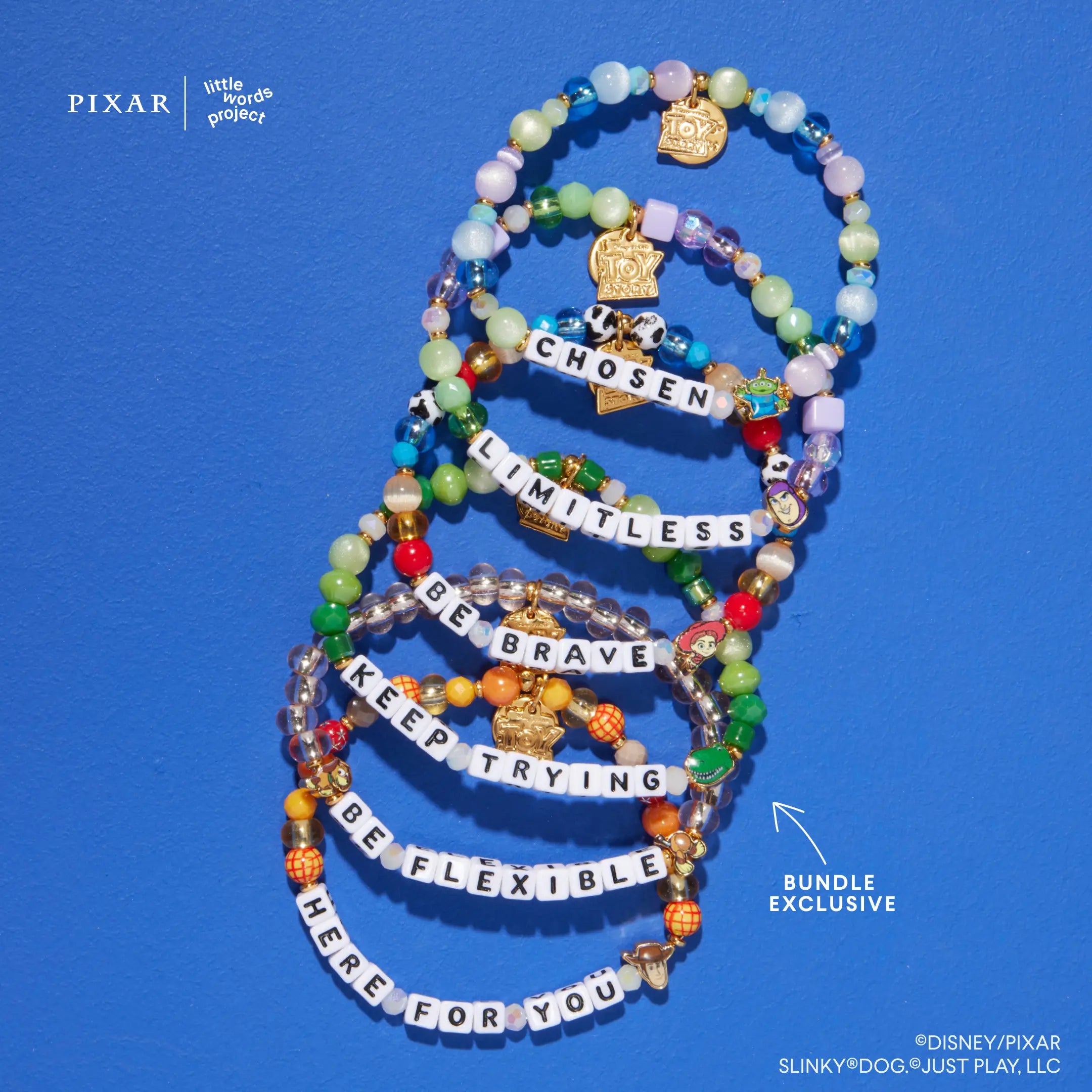 Deluxe Toy Story six-bracelet set with gold charms, flat lay on blue