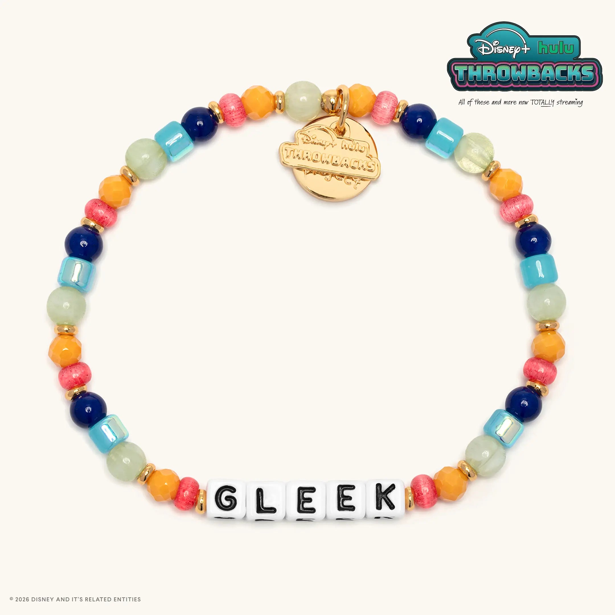 Gleek Disney+ Hulu Throwbacks bracelet with navy, light blue, orange, and coral beads, white letter beads, and a gold Throwbacks logo tag, flat lay on cream