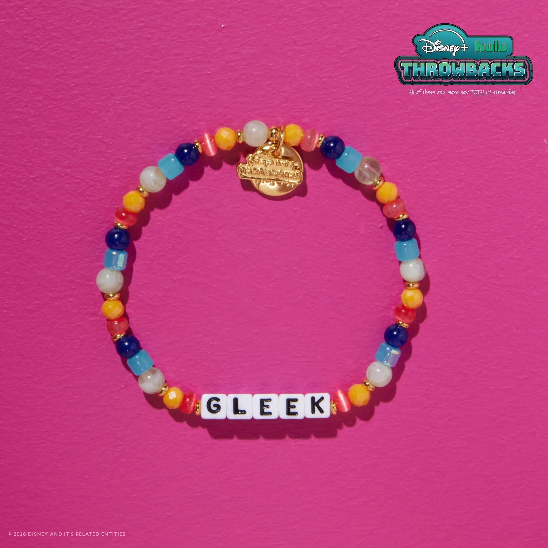 Gleek Disney+ Hulu Throwbacks bracelet on a hot pink background showing the gold Throwbacks logo tag