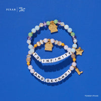 To Infinity and Beyond two-bracelet Toy Story set with gold charms on a blue background