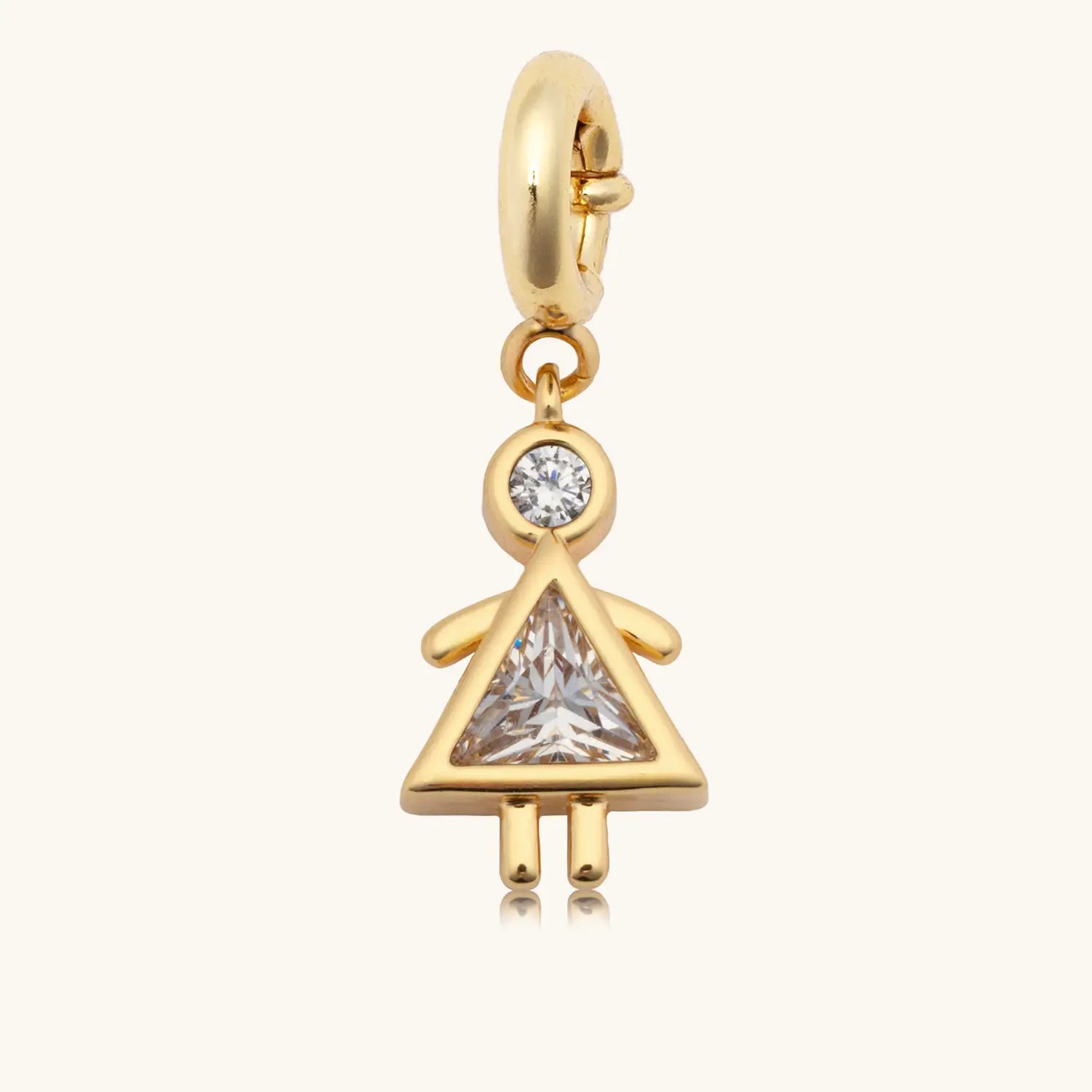 Gold charm with a central gemstone on a white background