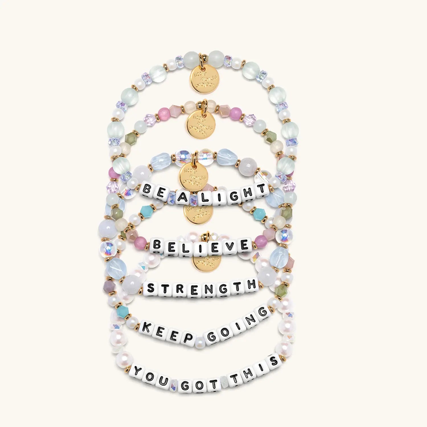 Set of beaded bracelets with motivational phrases on a white background