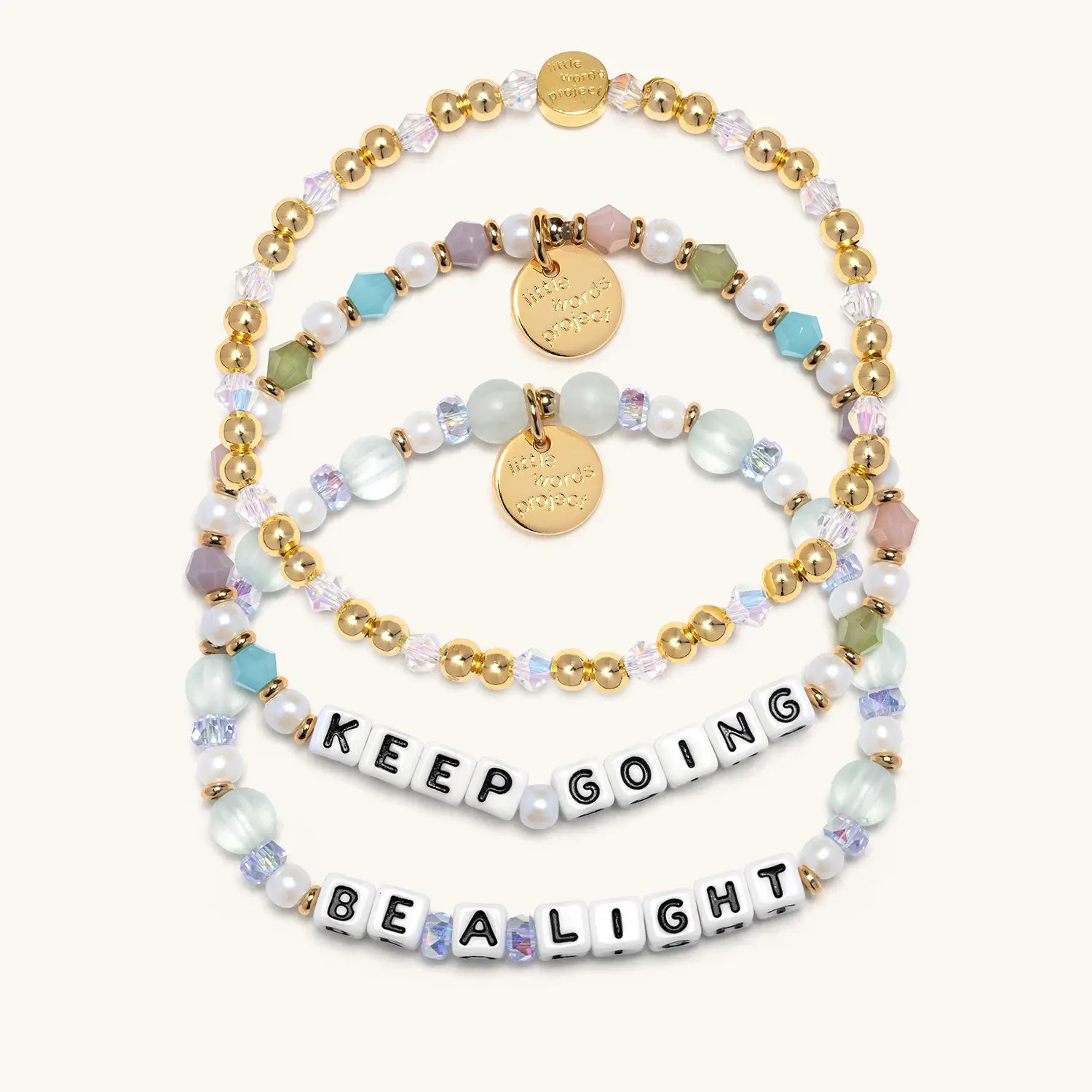 Set of beaded bracelets with motivational phrases on a white background