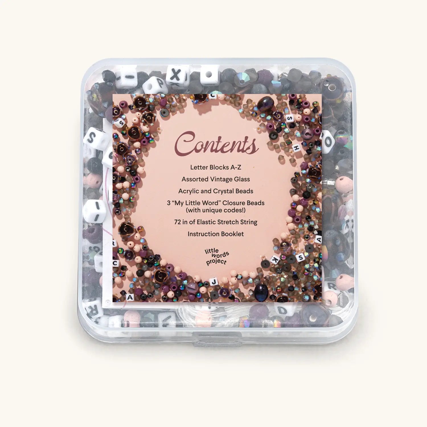 Container of assorted vintage glass beads with a label on a white background