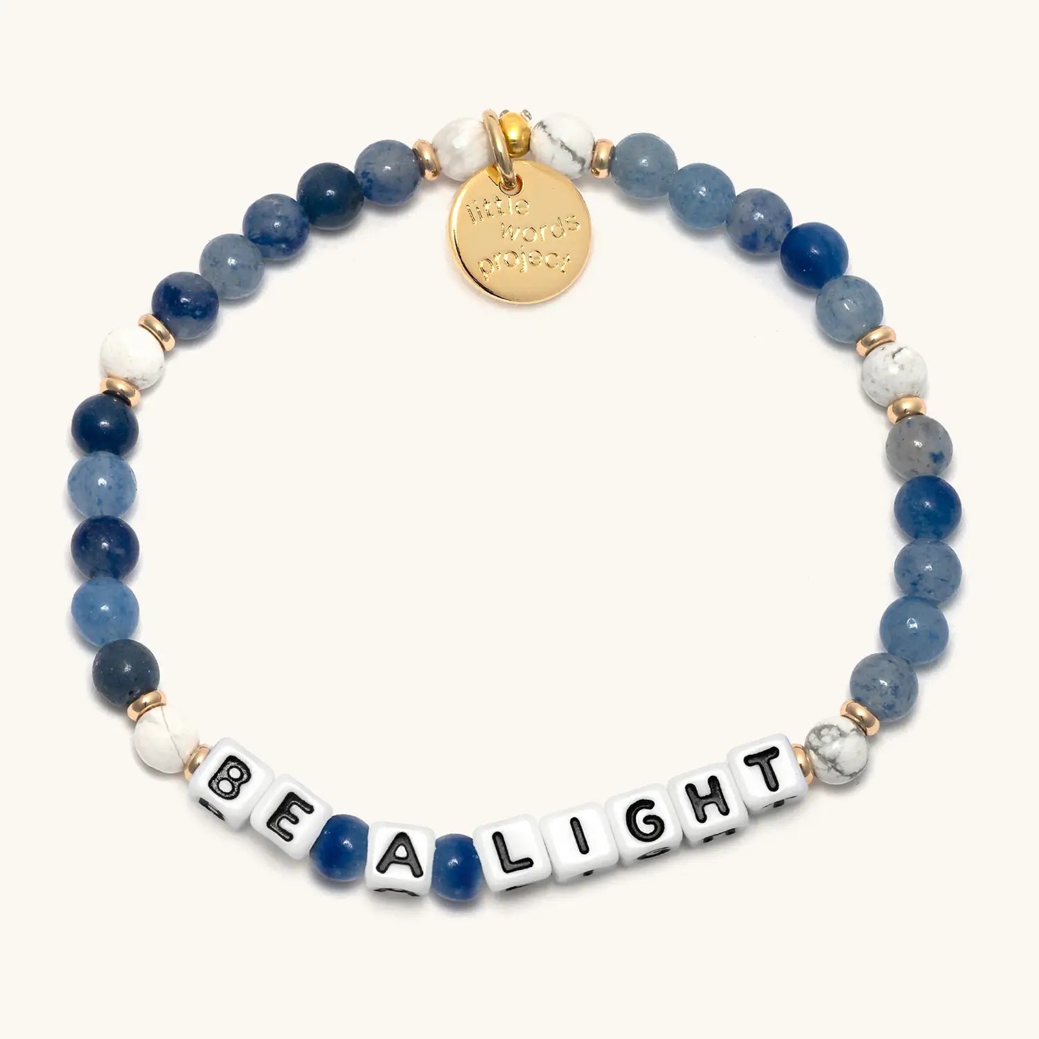 Bracelet with blue and white beads and a gold tag on a white background