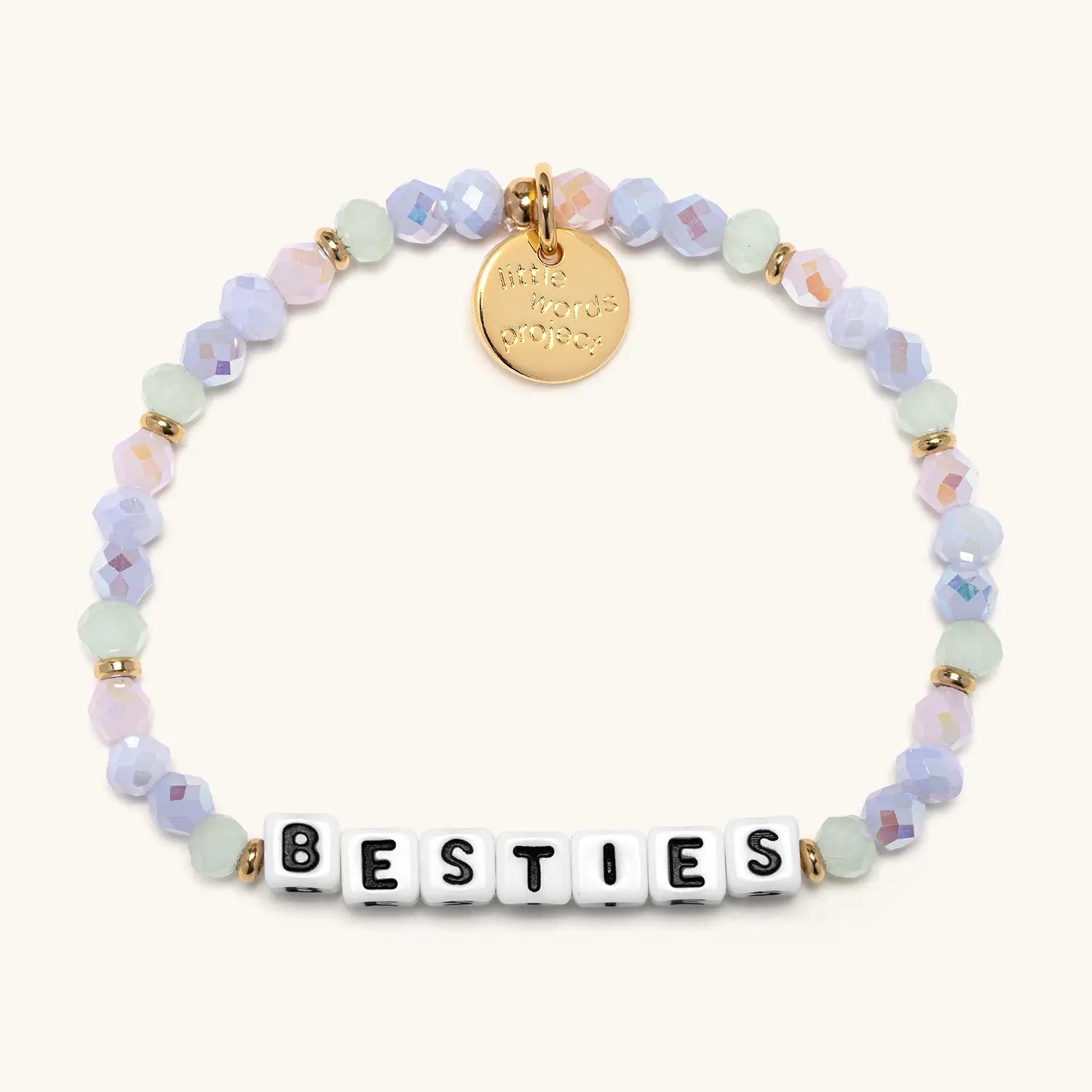 Beaded bracelet with 'BESTIES' beads and a gold tag on a white background
