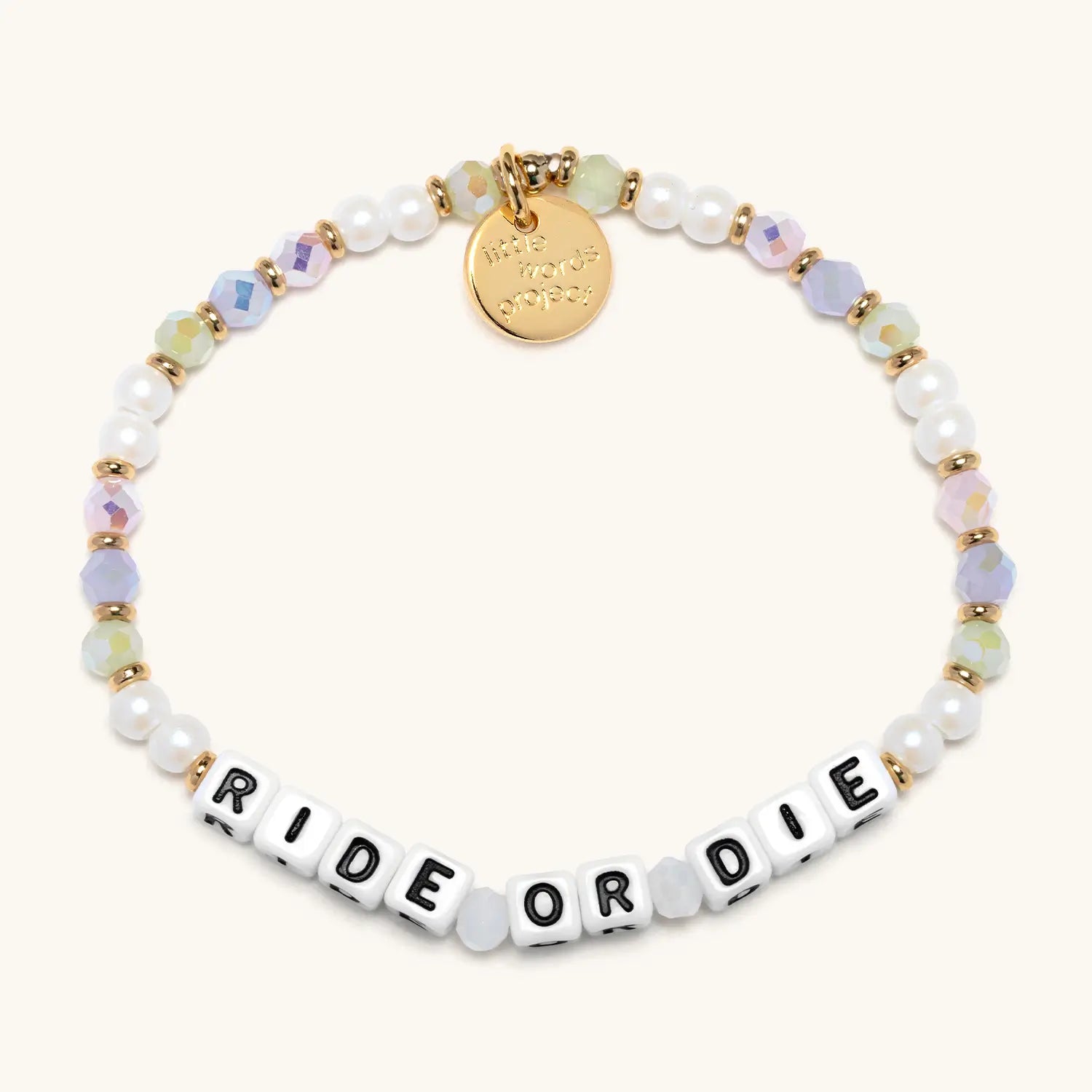 Bracelet with 'RIDE OR DIE' beads and gold tag on a white background